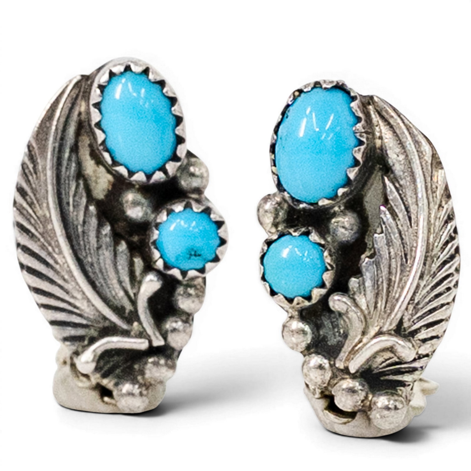 Vintage Navajo Sterling Silver & Turquoise Leaf Earrings Signed: Vintage Navajo Sterling Silver & Turquoise Leaf Earrings Signed 1970s–1980s, USA Pair of Navajo sterling silver clip earrings with repoussé feather and leaf motifs accented by bezel-set turquoise c
