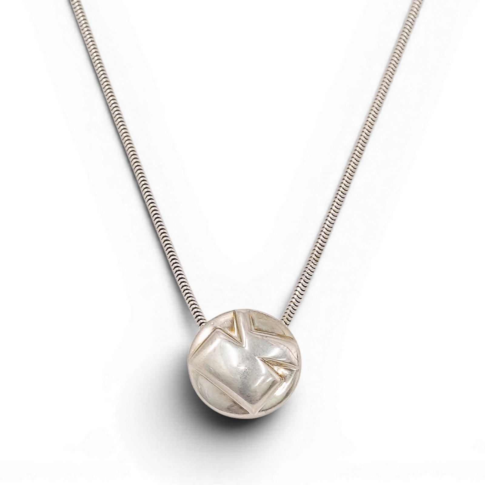 Tiffany & Co. Sterling Silver Modernist Initial Slider Necklace: Tiffany & Co. Sterling Silver Modernist Initial Slider Necklace 1990s, Italy Sterling silver snake chain necklace featuring a circular geometric slide pendant with angular abstract cutwork "K" design.