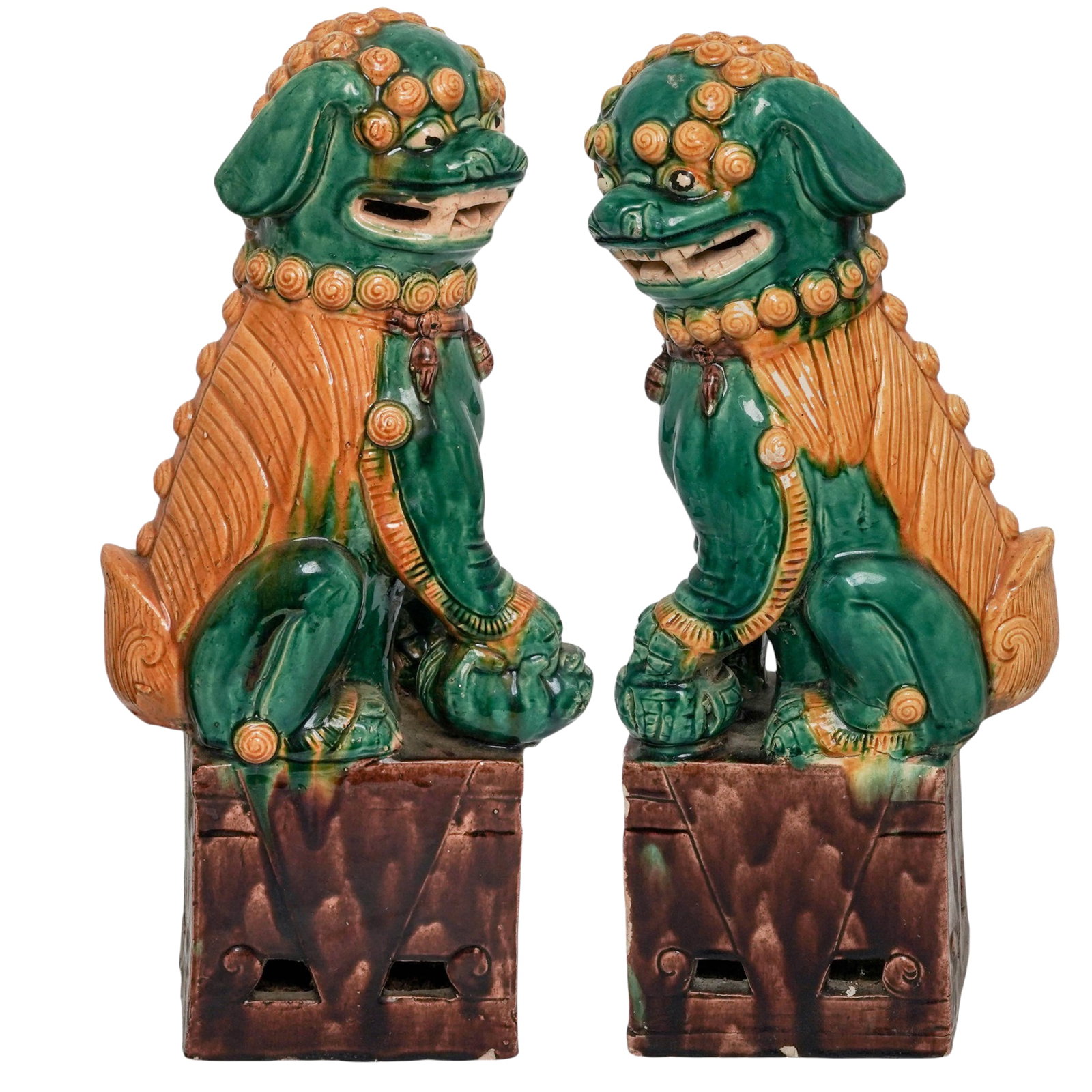 Pair Of Chinese Sancai Foo Dog Sculptures: Pair Of Chinese Sancai Foo Dog Sculptures Early 20th Cent., Chinese A pair of Chinese guardian lions, often called Foo Dogs, featuring a distinctive green and yellow sancai glaze. One lion is