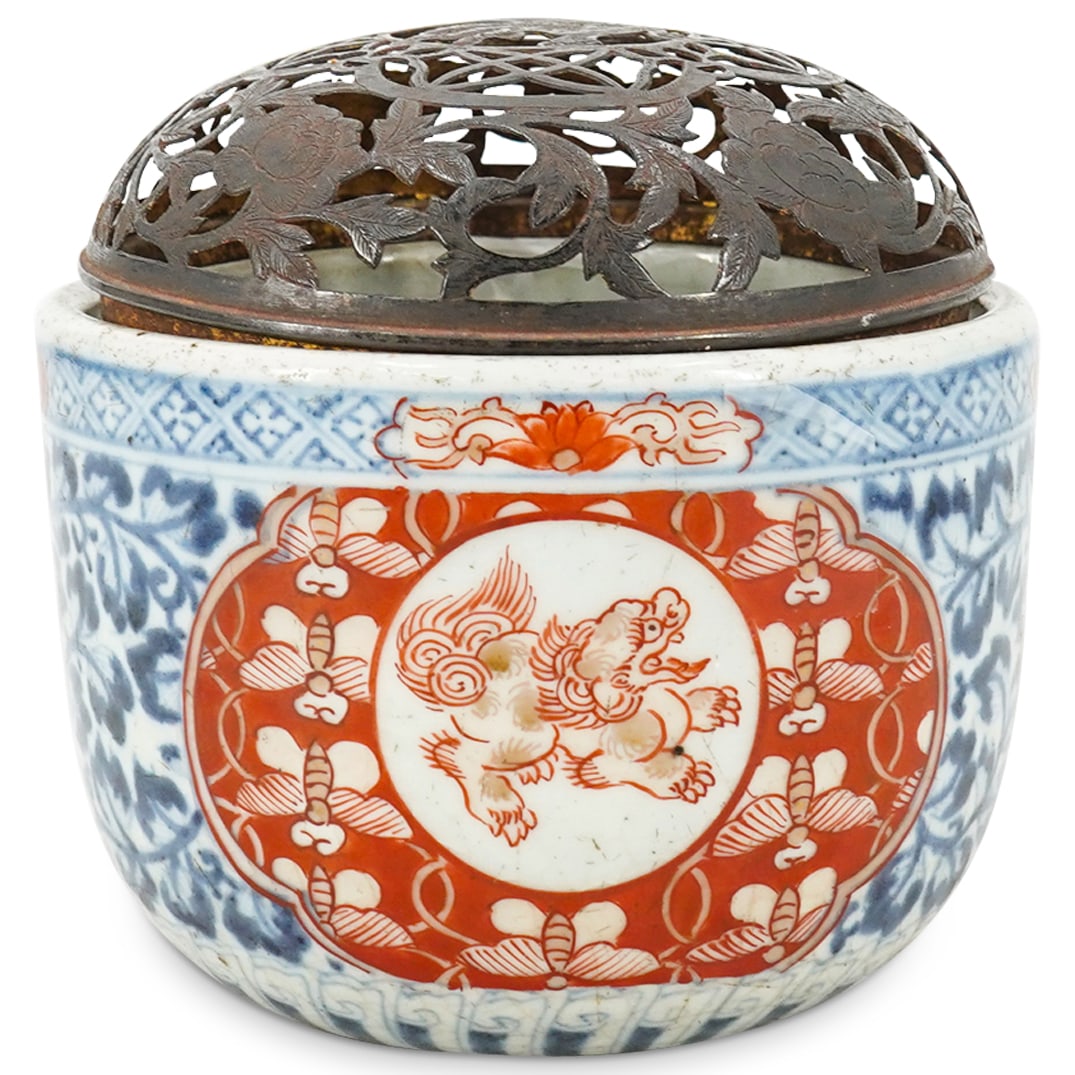 Antique Japanese Imari Porcelain Censer with Pierced Top: Antique Japanese Imari Porcelain Censer with Pierced Top Late 19th Cent. Japan An antique Japanese Porcelain Imari censor decorated with blue and red foliage and foo dog motifs, fitted at the top