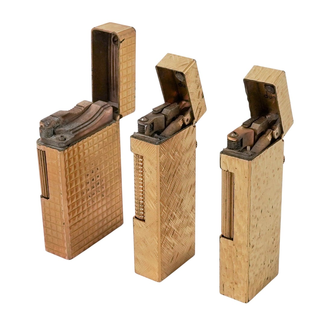 (3 pc) S.T. Dupont & Dunhill Gold-Plated Lighters: (3 pc) S.T. Dupont & Dunhill Gold-Plated Lighters Late 20th Century, Europe Collection of luxury pocket lighters in gold-plated finishes, featuring geometric engine-turned and hammered surface
