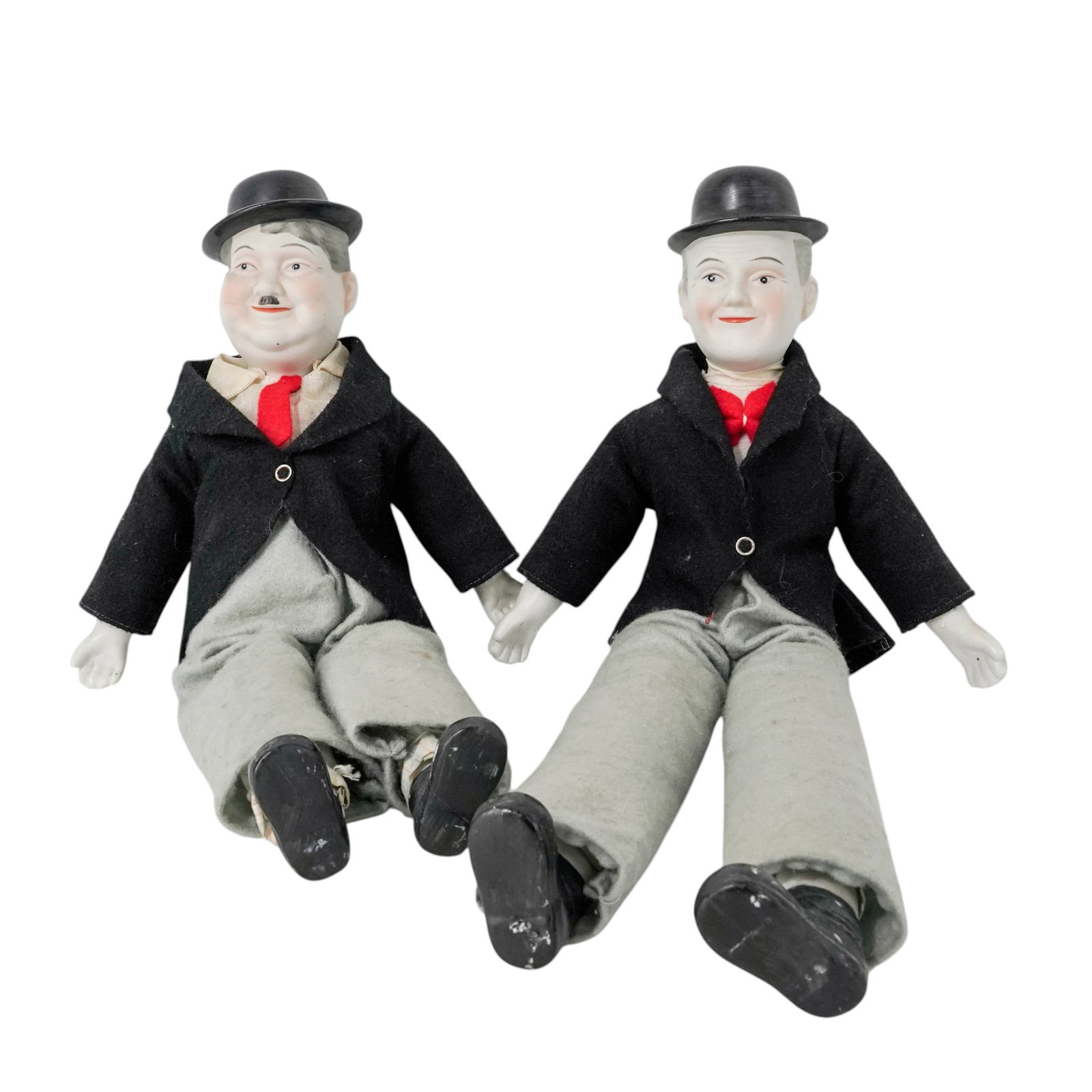 (2pc) Vintage Laurel & Hardy Porcelain Heads Dolls: (2pc) Vintage Laurel & Hardy Porcelain Heads Dolls Mid 20th Cent., American This pair of vintage collectible dolls depicts the legendary early 20th-century Hollywood comedy duo, Laurel and Hardy