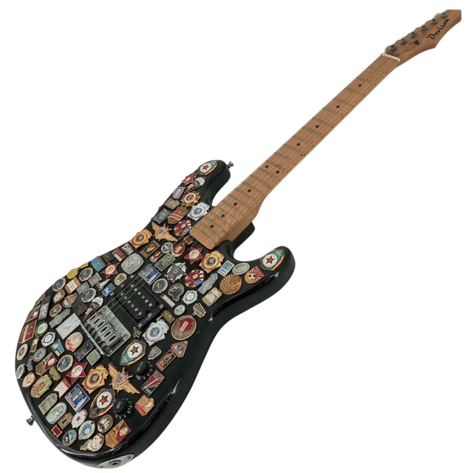 Russian "Stickerbomb" Davison Guitar Covered in Soviet-Era Metals/Pins: Russian "Stickerbomb" Davison Guitar Covered in Soviet-Era Metals/Pins 20th Cent, Russia Davison electric guitar extensively decorated in a “stickerbomb” style with an eclectic assortment of