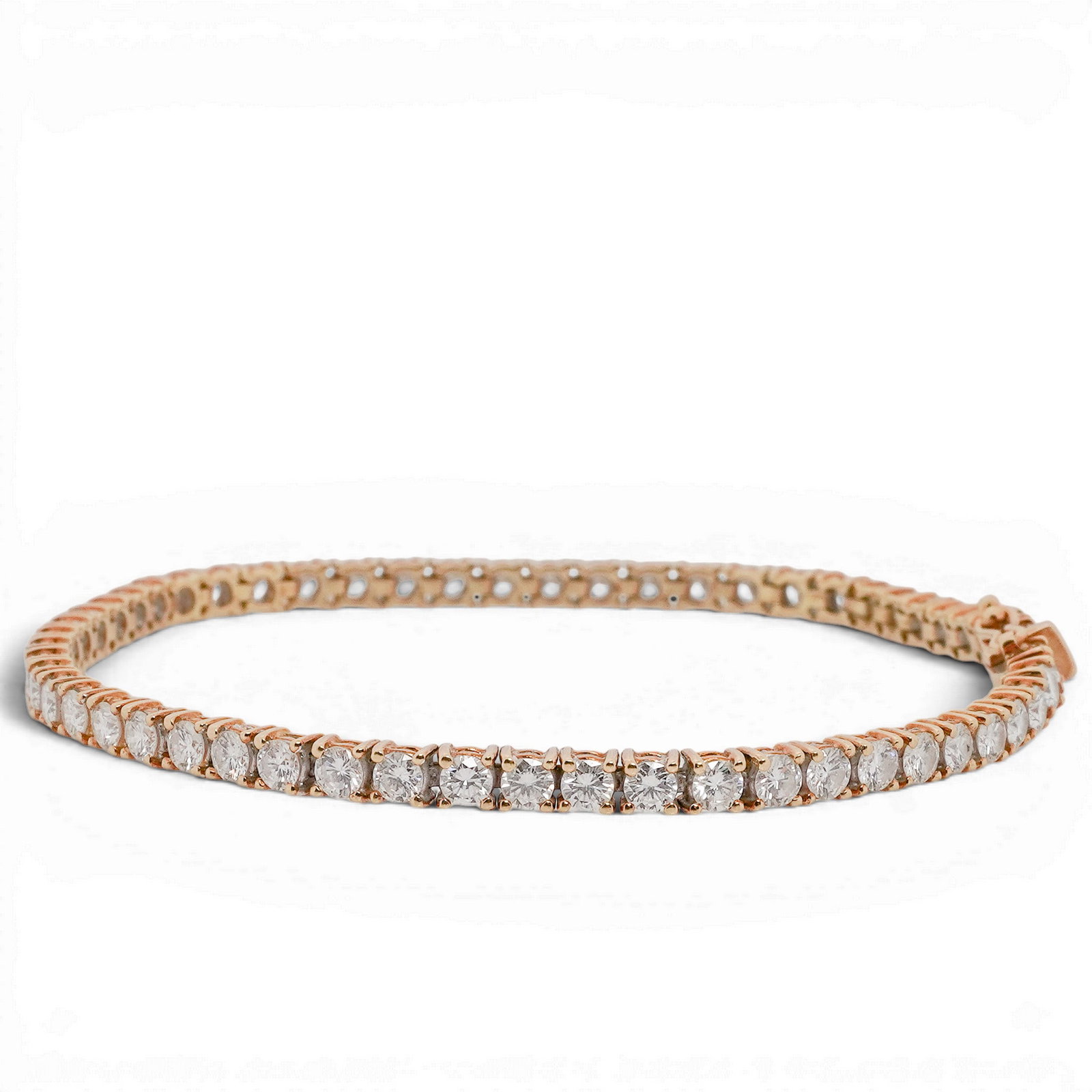 18k Gold & Diamond Tennis Bracelet: Tennis bracelet in 18k yellow gold set with G-H color, VS round brilliant cut diamonds totaling approximately 4.00 carats. Completed by a box clasp with safety latch. Stamped "18K", "750", and maker's