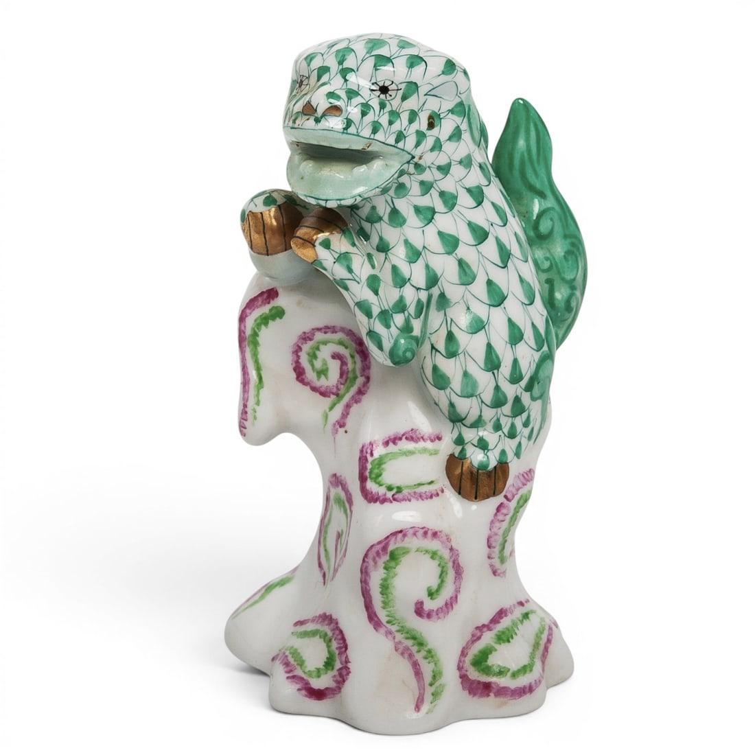 Herend Fishnet Foo Dog Porcelain Figurine: Herend Fishnet Foo Dog Porcelain Figurine Late 20th Century, Hungary Hand-painted porcelain Foo Dog (Guardian Lion) figurine by Herend Porcelain Manufactory, modeled perched atop a stylized rockwork b