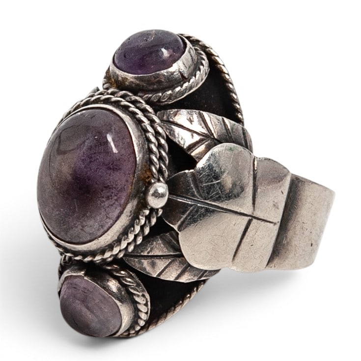 A Southwest sterling silver and fluorite cluster ring: A Southwest sterling silver and fluorite cluster ring Late 20th century Unmarked Tests for sterling. A heavy split-shank cluster ring set with three oval fluorite cabochons in serrated bezels, with tw