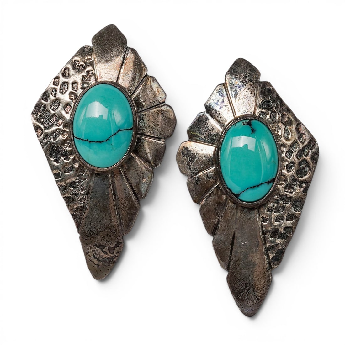 A pair of Southwest sterling silver and turquoise earrings: A pair of Southwest sterling silver and turquoise earrings Late 20th century Stamped: Sterling A pair of earrings, each set with an oval turquoise cabochon in a smooth bezel, mounted on a dimensional 