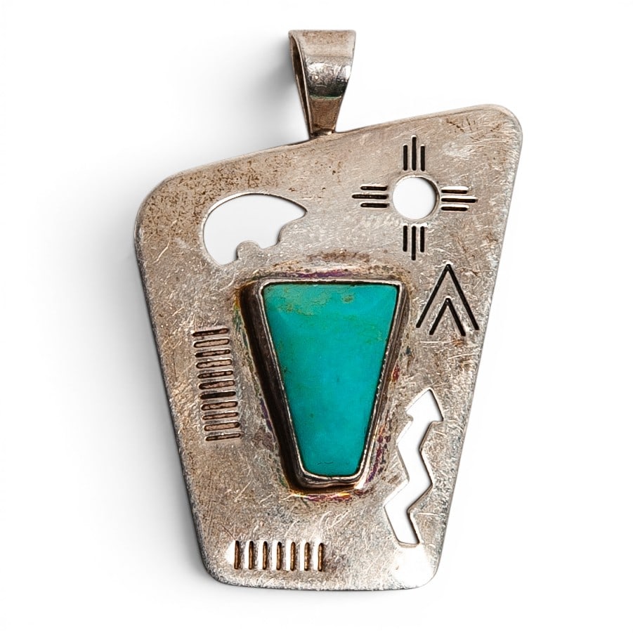 A Southwest sterling silver and turquoise geometric pendant: A Southwest sterling silver and turquoise geometric pendant Late 20th century Stamped: STER / [unidentified mark] / Copyright An irregular pierced plaque pendant set with a trapezoidal turquoise caboc