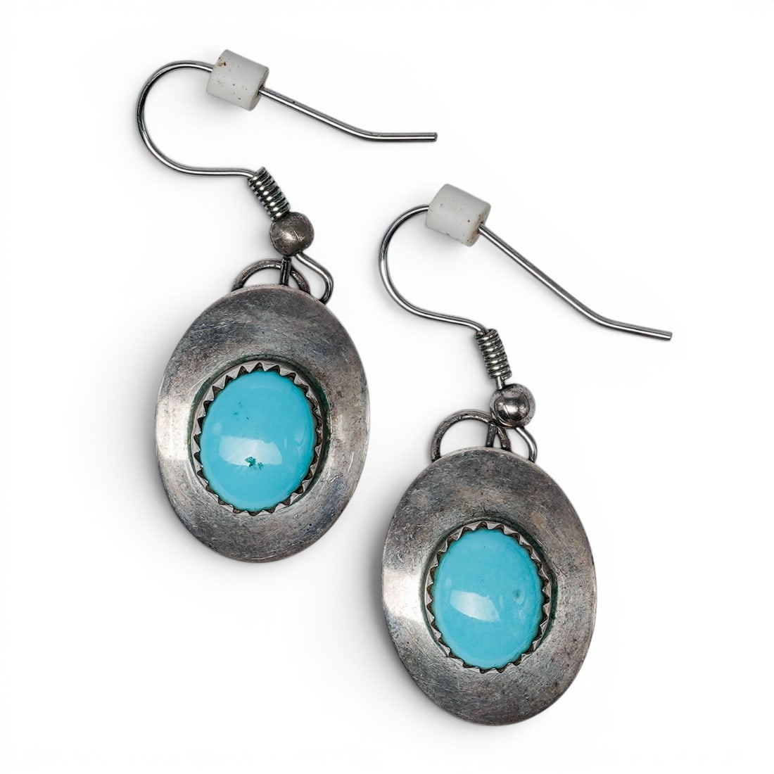 A pair of Joyce Vacit Tsethlikai Zuni sterling silver and turquoise dangle earrings: A pair of Joyce Vacit Tsethlikai Zuni sterling silver and turquoise dangle earrings Late 20th century Stamped: JV / 925 A pair of oval dangle earrings, each set with an oval turquoise cabochon in a se