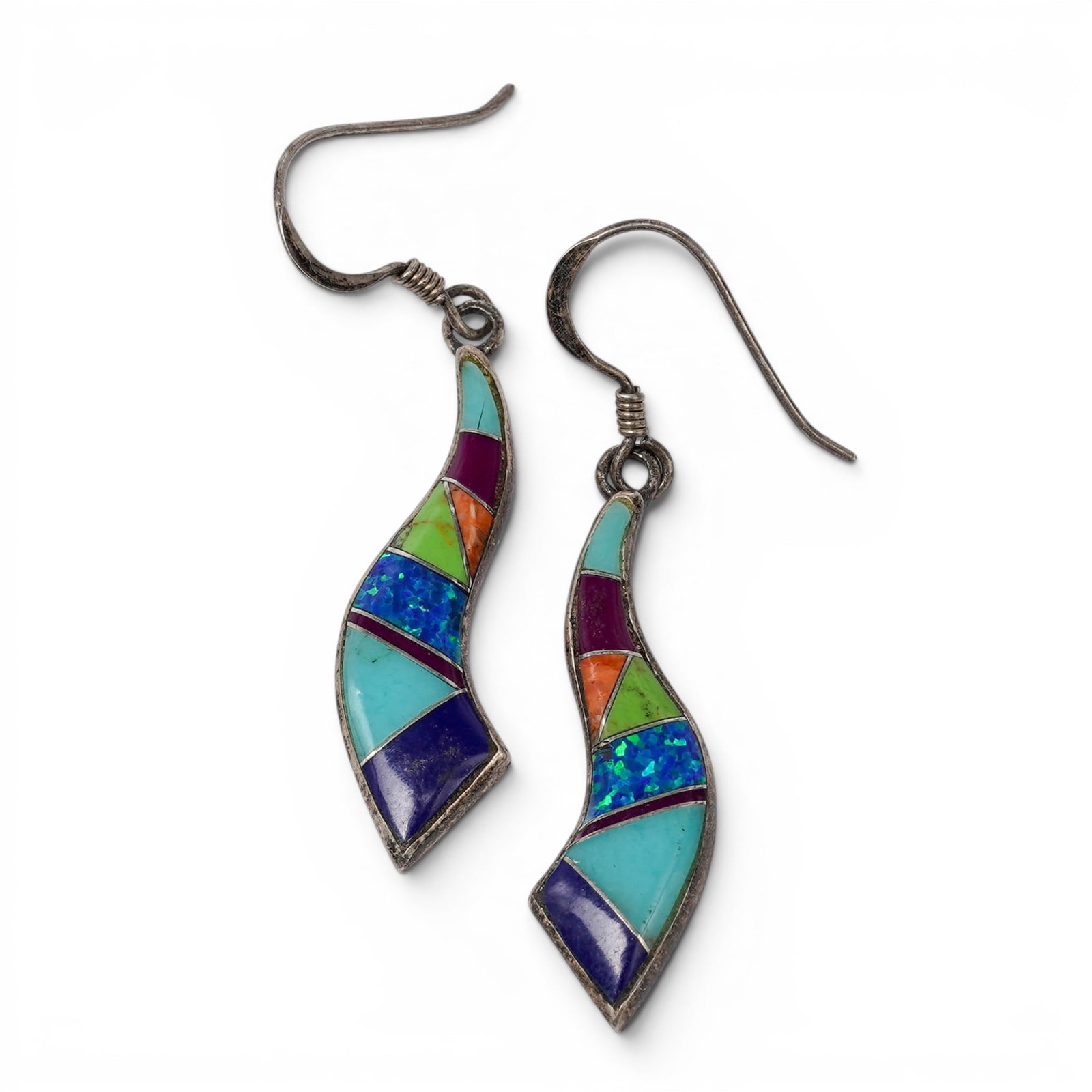 A pair of Ofina Pino Navajo sterling silver and multi-stone inlay dangle earrings: A pair of Ofina Pino Navajo sterling silver and multi-stone inlay dangle earrings Late 20th century Ofina Pino (Navajo) Stamped: O.P. / 925 A pair of dangle earrings with freeform curved silver drops 