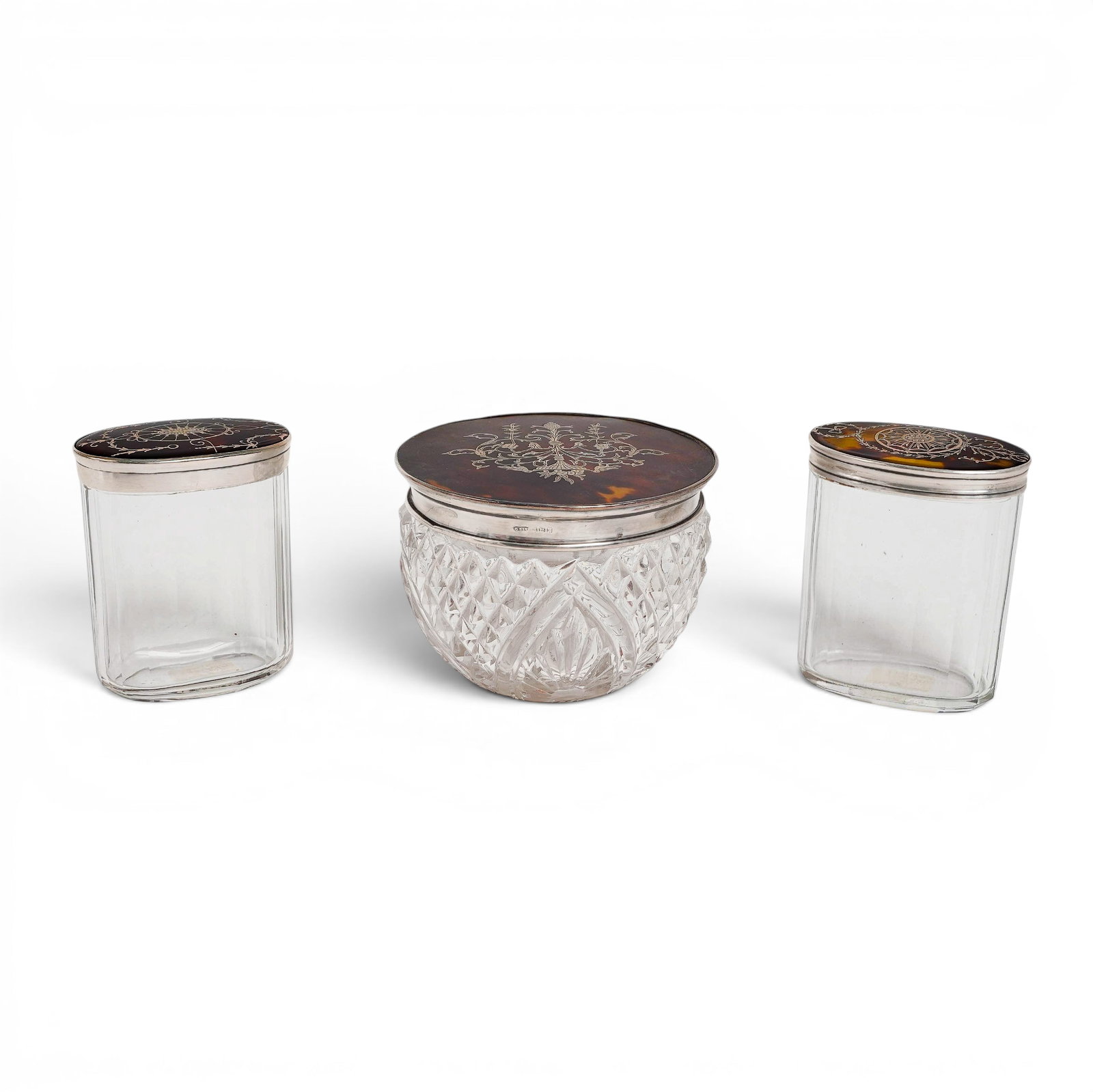 (3 pcs) English Sterling Silver & Tortoise Hued Glass Dresser Jars: (3 pcs) English Sterling Silver & Tortoise Hued Glass Dresser Jars Late 19th-early 20th century, English A three piece dresser jar set consisting of three glass jars with sterling silver and tortoise 