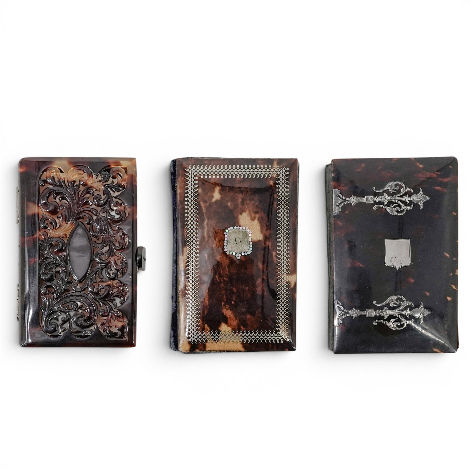 (3 pcs) Antique Tortoise Hued Notepads: (3 pcs) Antique Tortoise Hued Notepads Late 19th century A set of three antique tortoise-hued souvenir notepads. (1) Notepad with mother of pearl and sterling inlay with carved bone pencil. Front cove
