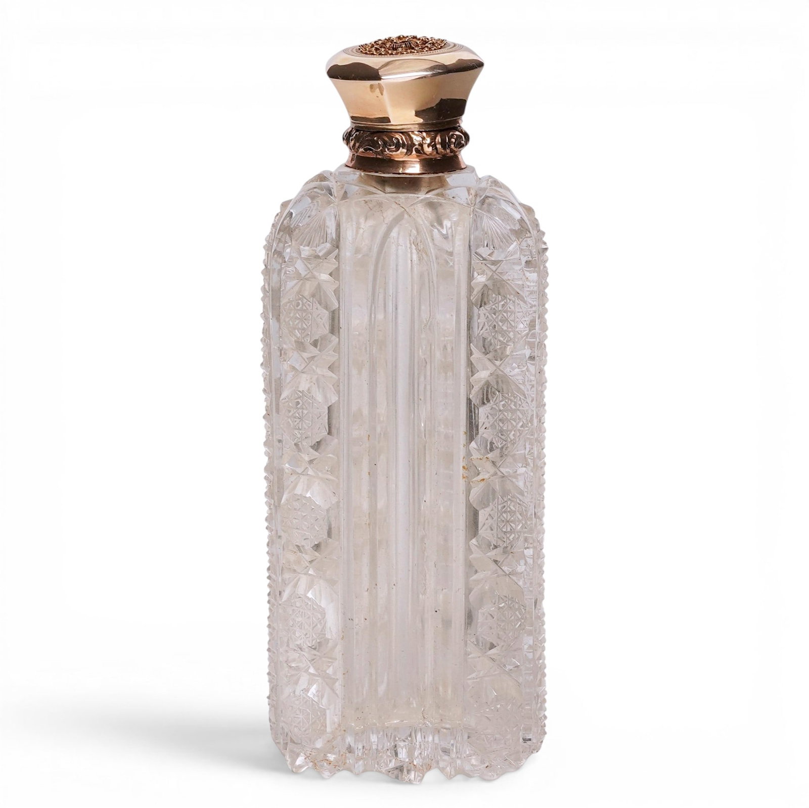 18k Gold Lidded Cut Crystal Perfume Bottle: 18k Gold Lidded Cut Crystal Perfume Bottle 19th Cent, Europe Cut crystal perfume bottle with faceted body and decorative patterning. Fitted with an 18K gold lid. Clear crystal construction with
