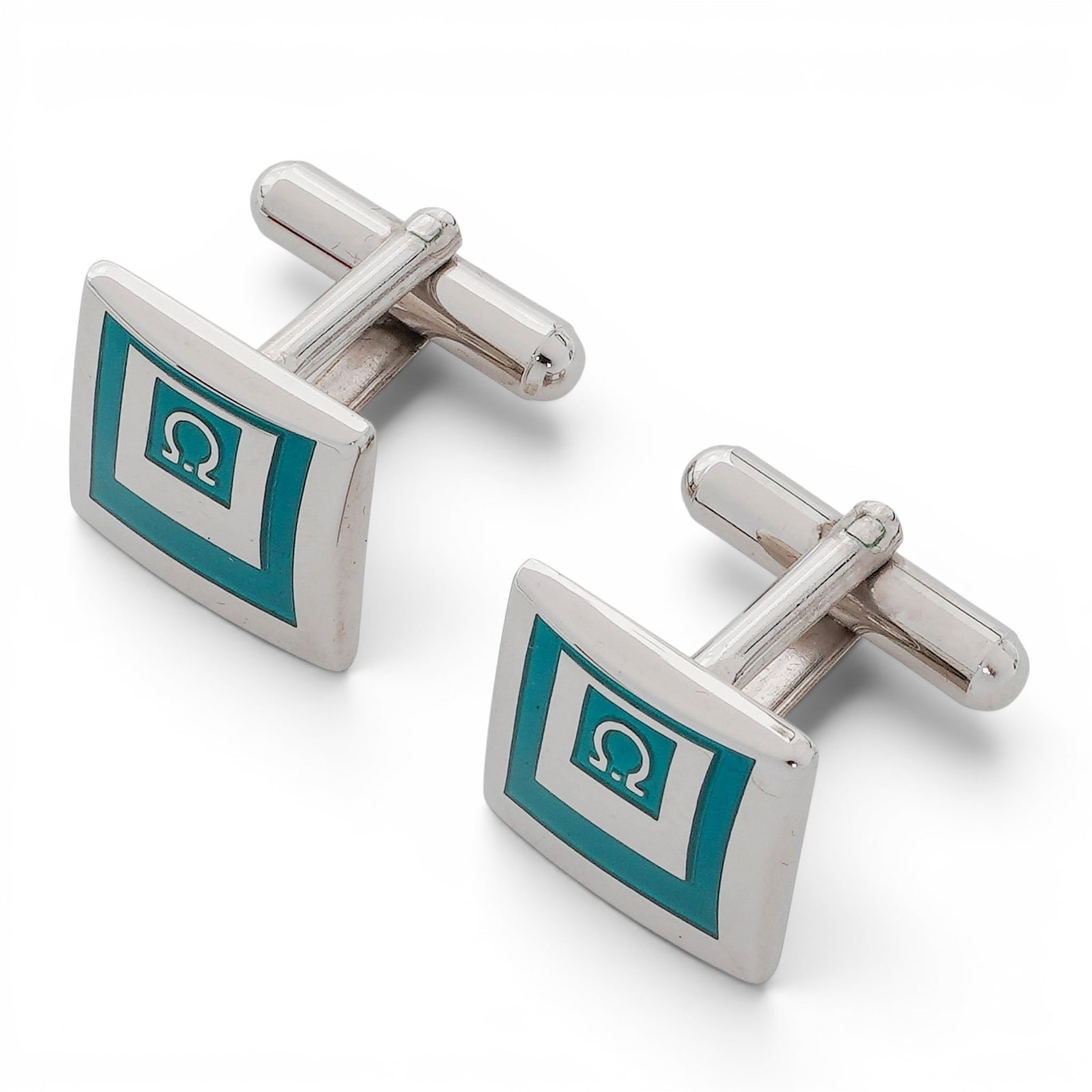 Vintage Salvatore Ferragamo Logo Enamel Cufflinks: Vintage Salvatore Ferragamo Logo Enamel Cufflinks Late 20th Century, Italy Pair of Salvatore Ferragamo cufflinks featuring square-form faces decorated with teal enamel panels and the Ferragamo logo mo
