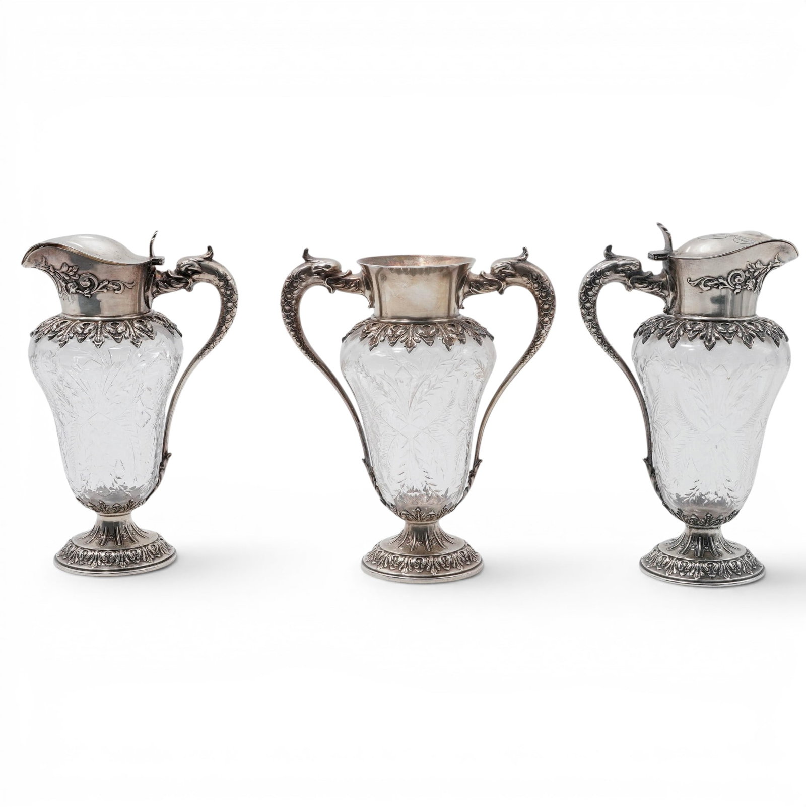 (3 pc) Antique Sterling Silver Mounted Crystal Syrup Pitchers & Urn: (3 pc) Antique Sterling Silver Mounted Crystal Syrup Pitchers & Urn 19th - Early 20th Cent, USA Group comprising two crystal syrup pitchers and one crystal urn, each fitted with sterling silver