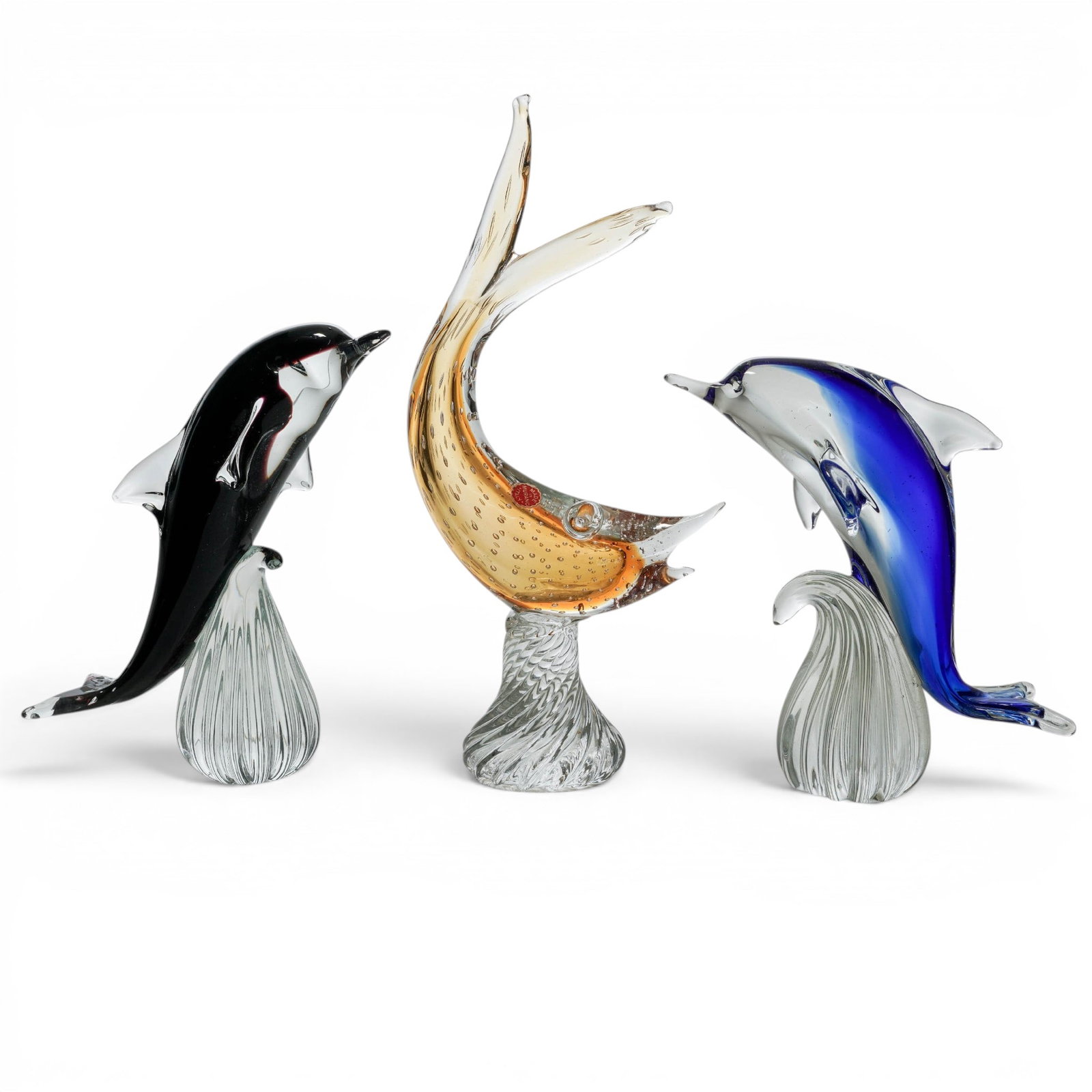 (3pc) Murano Glass Marine Life Figurines Group: (3pc) Murano Glass Marine Life Figurines Group 20th Cent., Italian The group includes: (1)Sommerso black dolphin figurine. H: 9 3/8" W: 4" D: 10" (1)Cobalt blue Dolphin figurine. H: 8 5/8" W: 3 1/2"