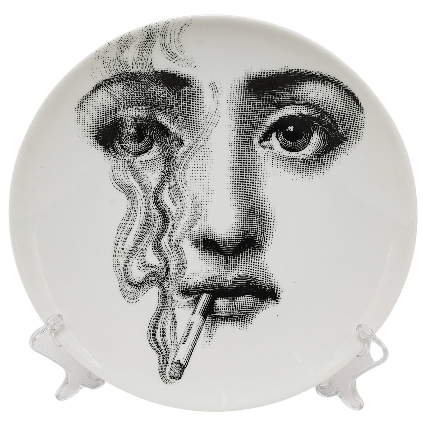 Fornasetti "Tema a Variazioni" No. 81 Wall Plate: Fornasetti "Tema a Variazioni" No. 81 Wall Plate Late 20th Cent - 21st Cent, Italy Fornasetti "Tema e Variazioni" No. 81 porcelain wall plate decorated in black and white with the iconic portrait of L