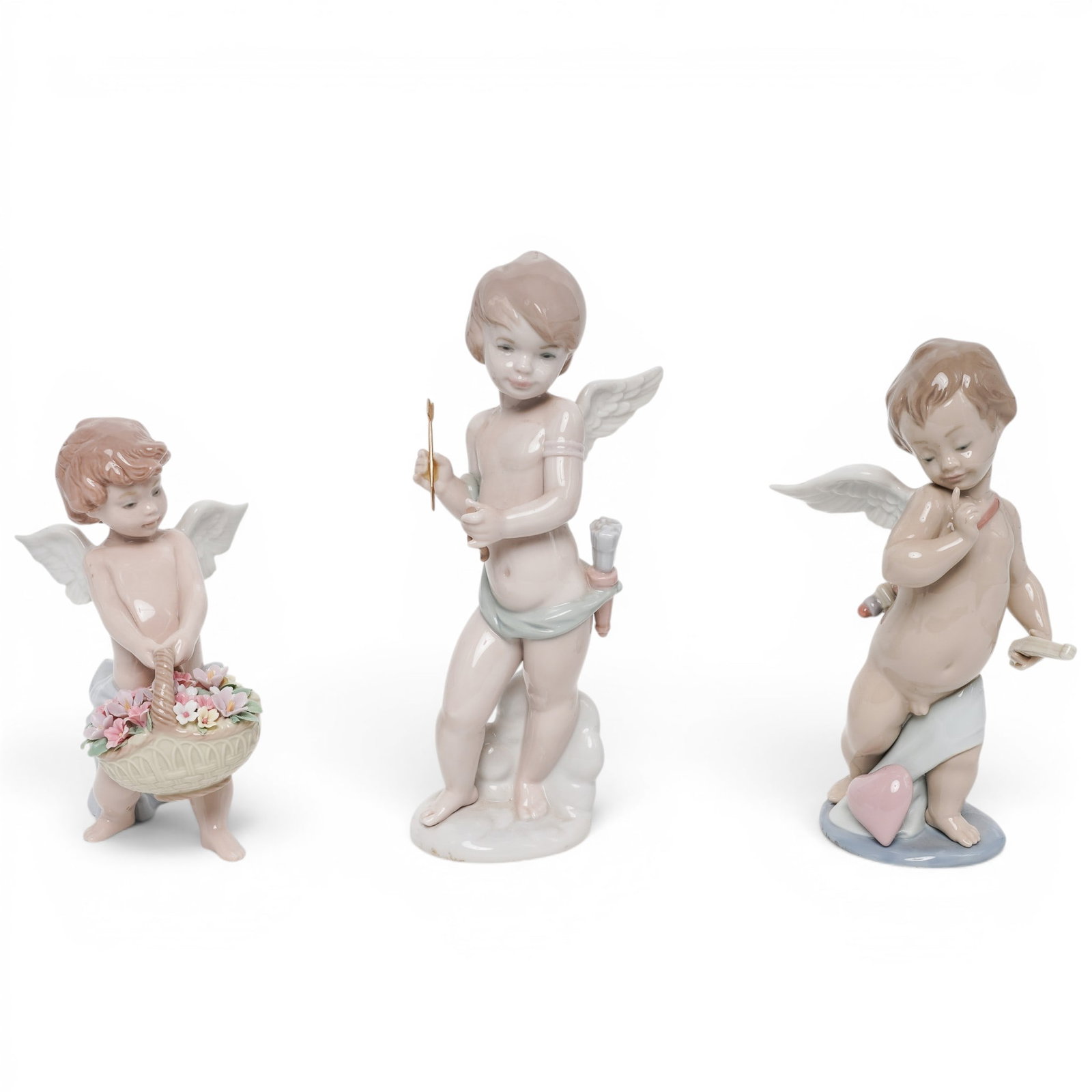 (3 pc) Lladro Porcelain Cherub Figurines: (3 pc) Lladro Porcelain Cherub Figurines Late 20th Cent, Spain (1) "Cupid" model #6311 (1) "Heaven's Harvest" model #6772 (1) "Cupid's Arrow" model #6596 Each porcelain figurine depicts a cherub hold