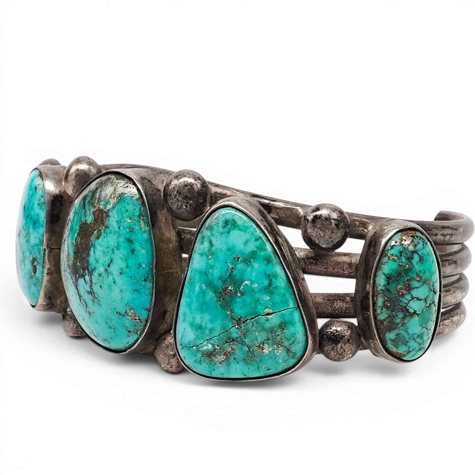 A Navajo Silver And Turquoise Five Stone Cuff Bracelet: A Navajo Silver And Turquoise Five Stone Cuff Bracelet Late 20th century Unmarked. Tested sterling silver. A cuff bracelet with five oval bezel set turquoise cabochons with visible matrix, connected b