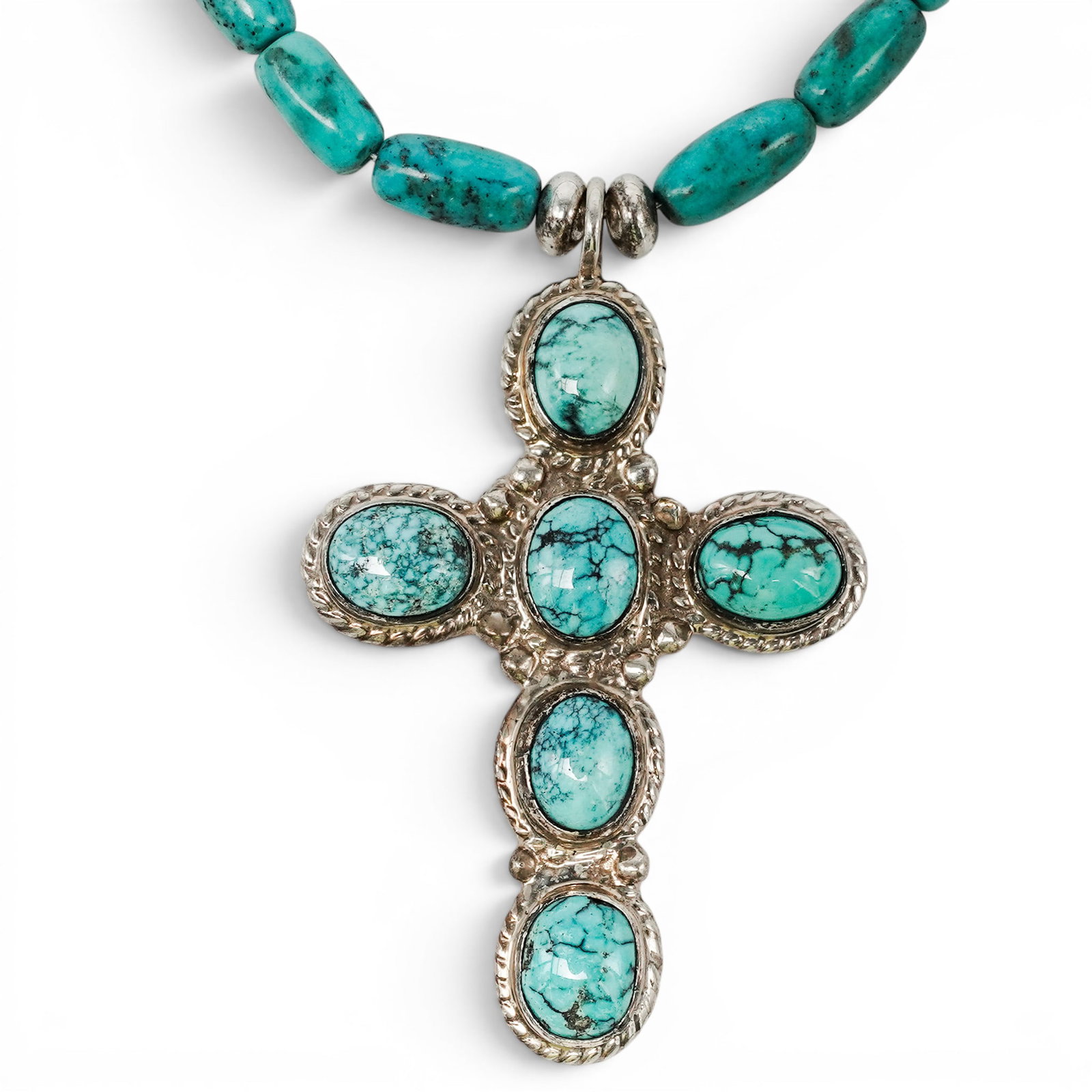 A John Chavez Navajo Sterling Silver And Turquoise Cross Pendant Necklace: A John Chavez Navajo Sterling Silver And Turquoise Cross Pendant Necklace Late 20th century Stamped: J.J. / Sterling A necklace composed of graduated turquoise heishi beads suspending a cross-form pen