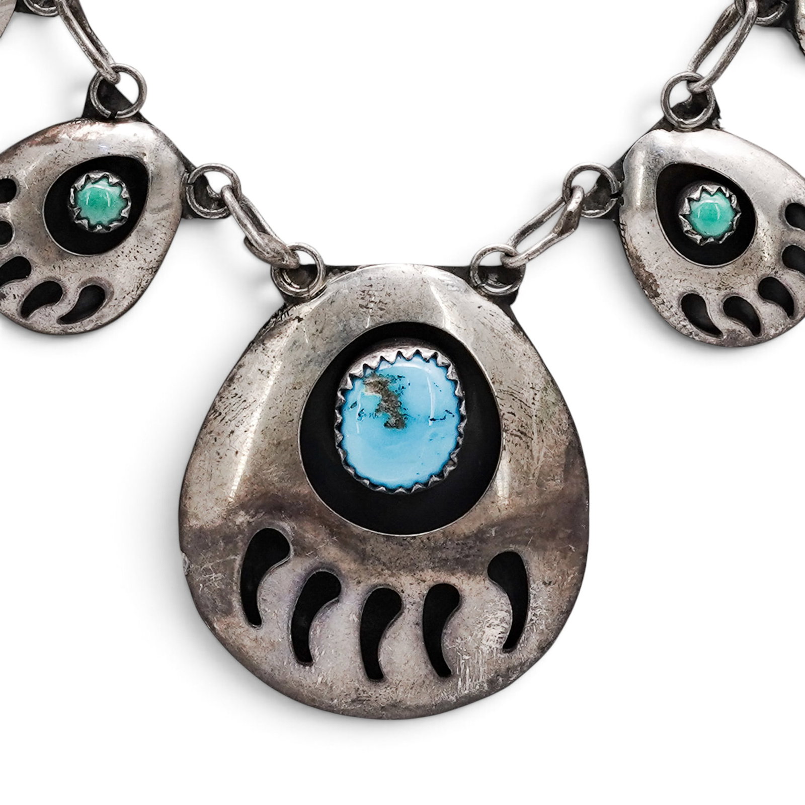 A Navajo Sterling Silver And Turquoise Bear Paw Link Necklace: A Navajo Sterling Silver And Turquoise Bear Paw Link Necklace Late 20th century Unmarked. Tested sterling silver. A necklace composed of eight bear paw-form links, each set with a turquoise cabochon i