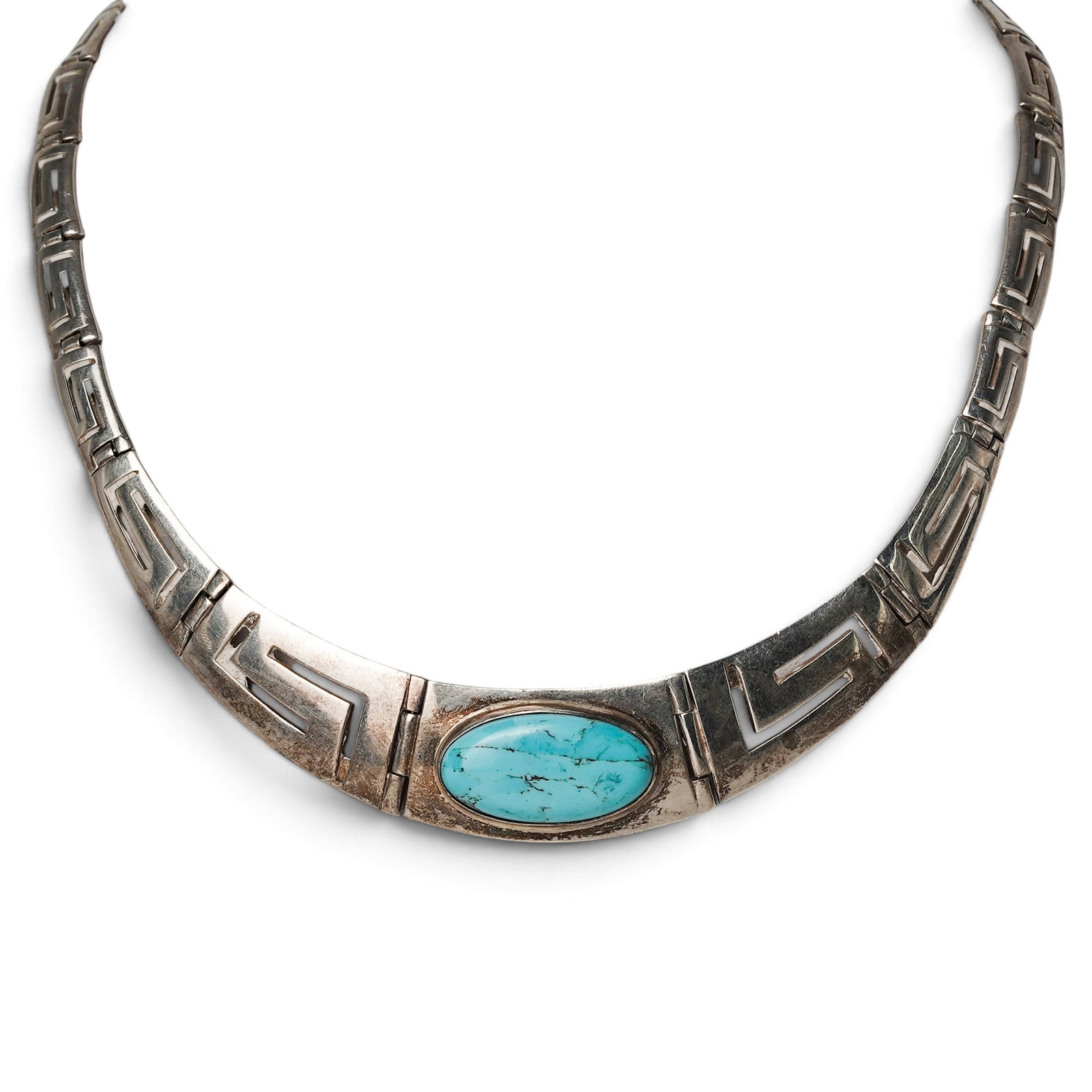 A Navajo Sterling Silver And Turquoise Geometric Link Collar Necklace: A Navajo Sterling Silver And Turquoise Geometric Link Collar Necklace Late 20th century Unmarked. Tested sterling silver. A collar necklace composed of articulated geometric silver links, centered by 