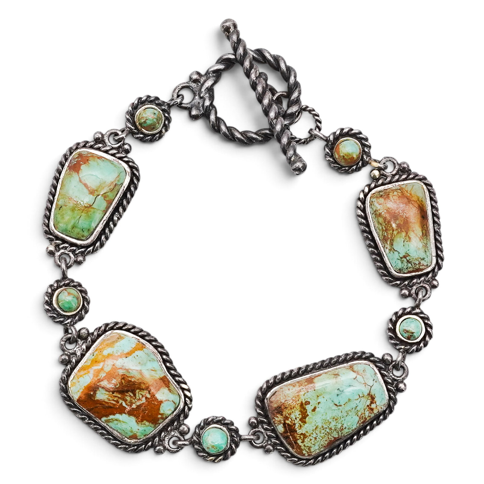 A Navajo Sterling Silver And Turquoise Link Bracelet: A Navajo Sterling Silver And Turquoise Link Bracelet Late 20th century Stamped: .925. An articulated bracelet composed of large freeform and rectangular bezel-set turquoise cabochons joined by smaller