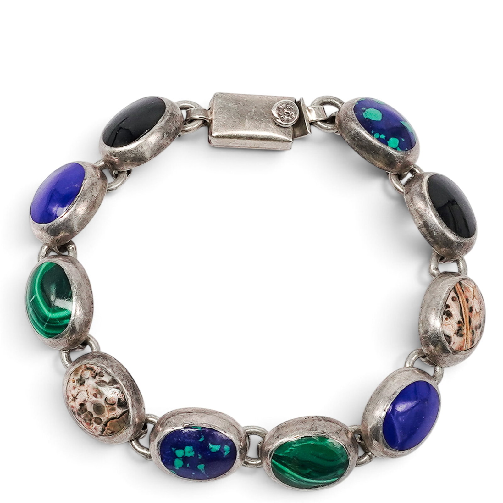 A Mexican Sterling Silver And Multistone Cabochon Link Bracelet: A Mexican Sterling Silver And Multistone Cabochon Link Bracelet Late 20th century Stamped: TC-137 / Mexico / 925 A bracelet composed of alternating oval cabochon links in lapis lazuli, malachite, onyx