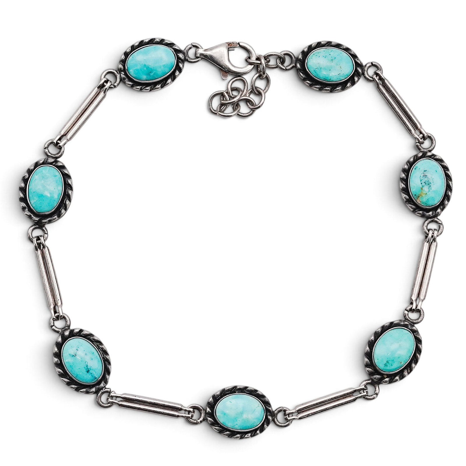 A Quoc Turquoise Inc. Sterling Silver And Turquoise Link Bracelet: A Quoc Turquoise Inc. Sterling Silver And Turquoise Link Bracelet Late 20th century Stamped: Q.T. / Trademark hallmark / .925. A link bracelet composed of oval bezel-set turquoise cabochons within rop