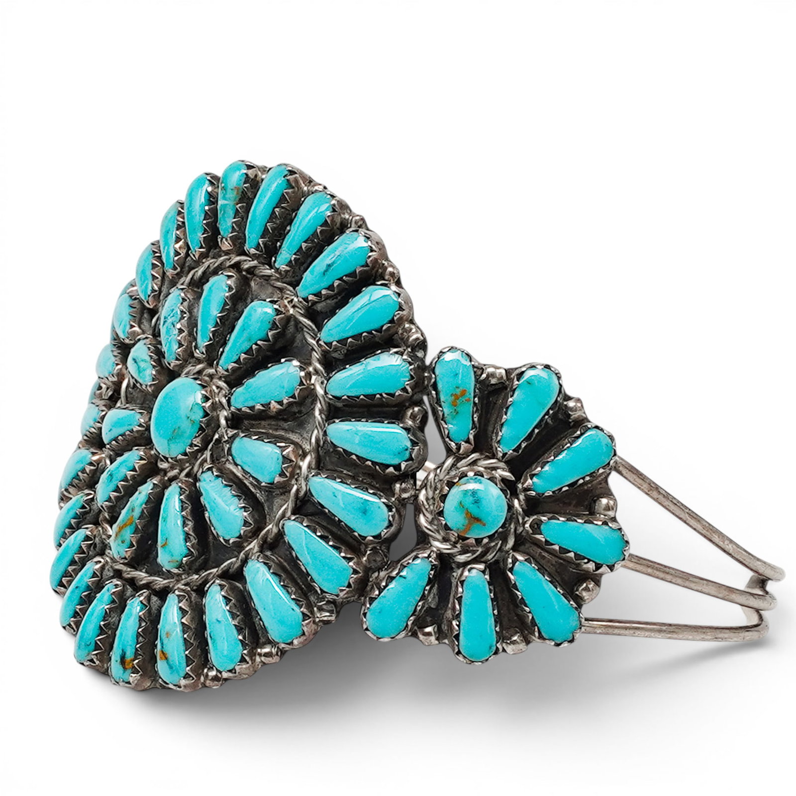A Mathilda Benally Zuni Sterling Silver And Turquoise Needlepoint Cuff Bracelet: A Mathilda Benally Zuni Sterling Silver And Turquoise Needlepoint Cuff Bracelet Late 20th century Stamped: M.B. / Sterling. A cuff bracelet with a large radiating cluster of needlepoint turquoise ston
