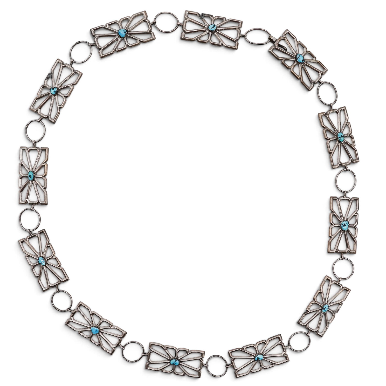 A Navajo Sterling Silver And Turquoise Openwork Concho Belt: A Navajo Sterling Silver And Turquoise Openwork Concho Belt Late 20th century Unmarked. Tested sterling silver. A concho belt composed of rectangular openwork conchos with radiating geometric motifs a