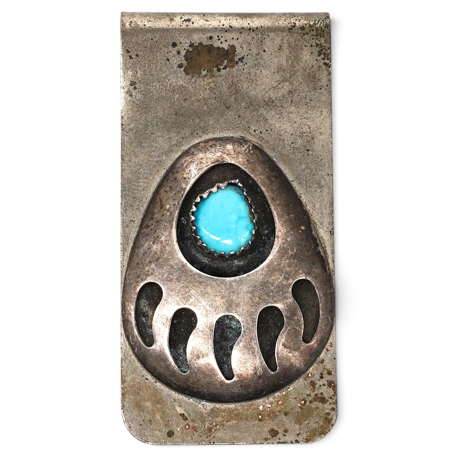 A Navajo Sterling Silver And Turquoise Bear Paw Money Clip: A Navajo Sterling Silver And Turquoise Bear Paw Money Clip Late 20th century Stamped: Illegible hallmark. Tested sterling silver. A silver money clip with an applied bear paw motif centered by a bezel