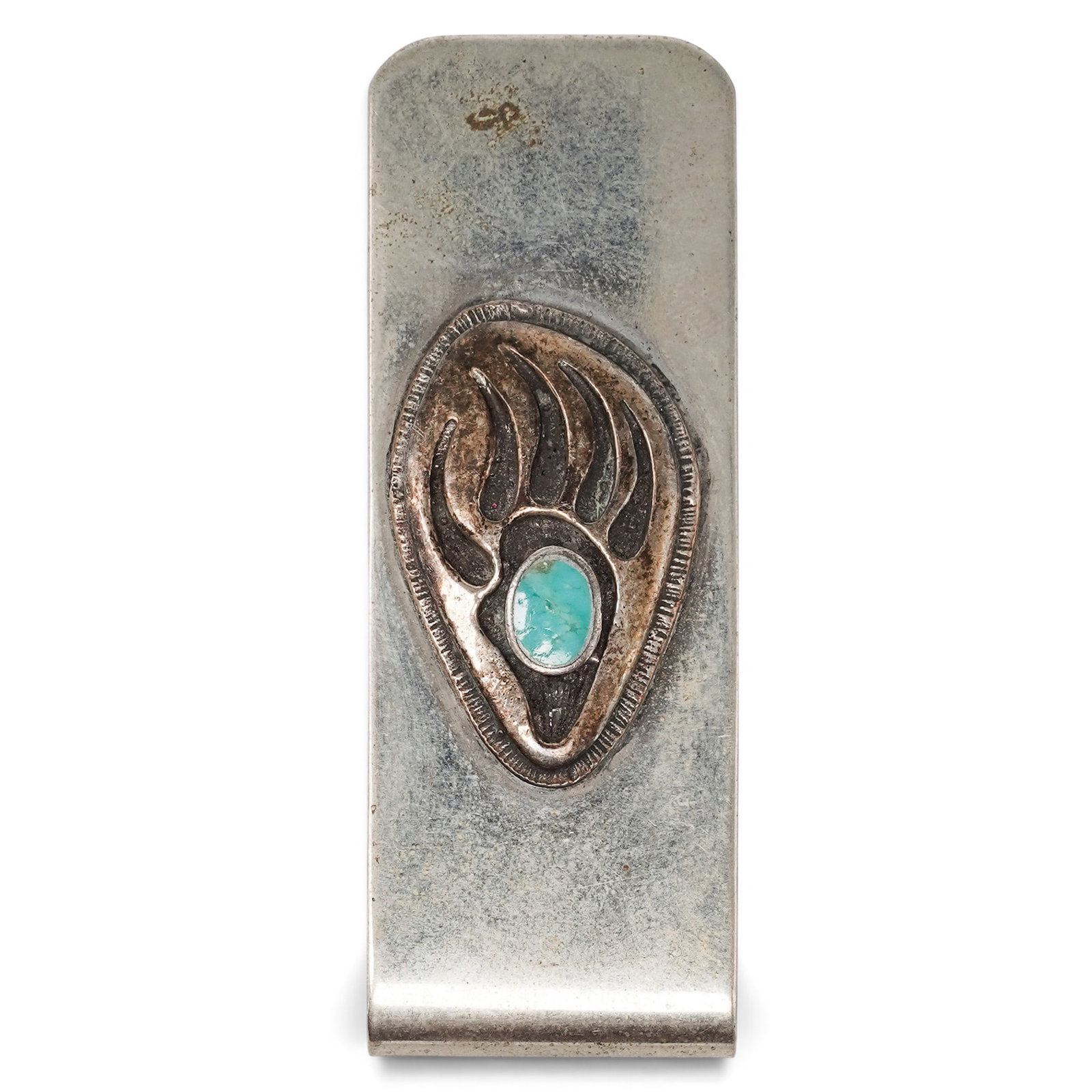 A Navajo Sterling Silver And Turquoise Bear Paw Money Clip: A Navajo Sterling Silver And Turquoise Bear Paw Money Clip Late 20th century Unmarked. Tested sterling silver. A silver money clip with an applied bear paw motif centered by a bezel-set turquoise cabo