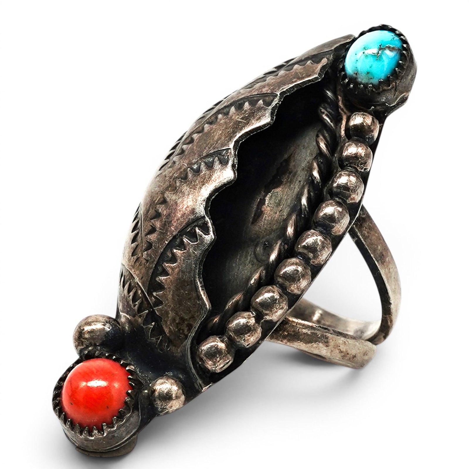 A Navajo Sterling Silver, Turquoise, And Coral Shadowbox Ring: A Navajo Sterling Silver, Turquoise, And Coral Shadowbox Ring Late 20th century Unmarked. Tested sterling silver. A split shank ring with an elongated shadowbox center framed by silver beadwork and st