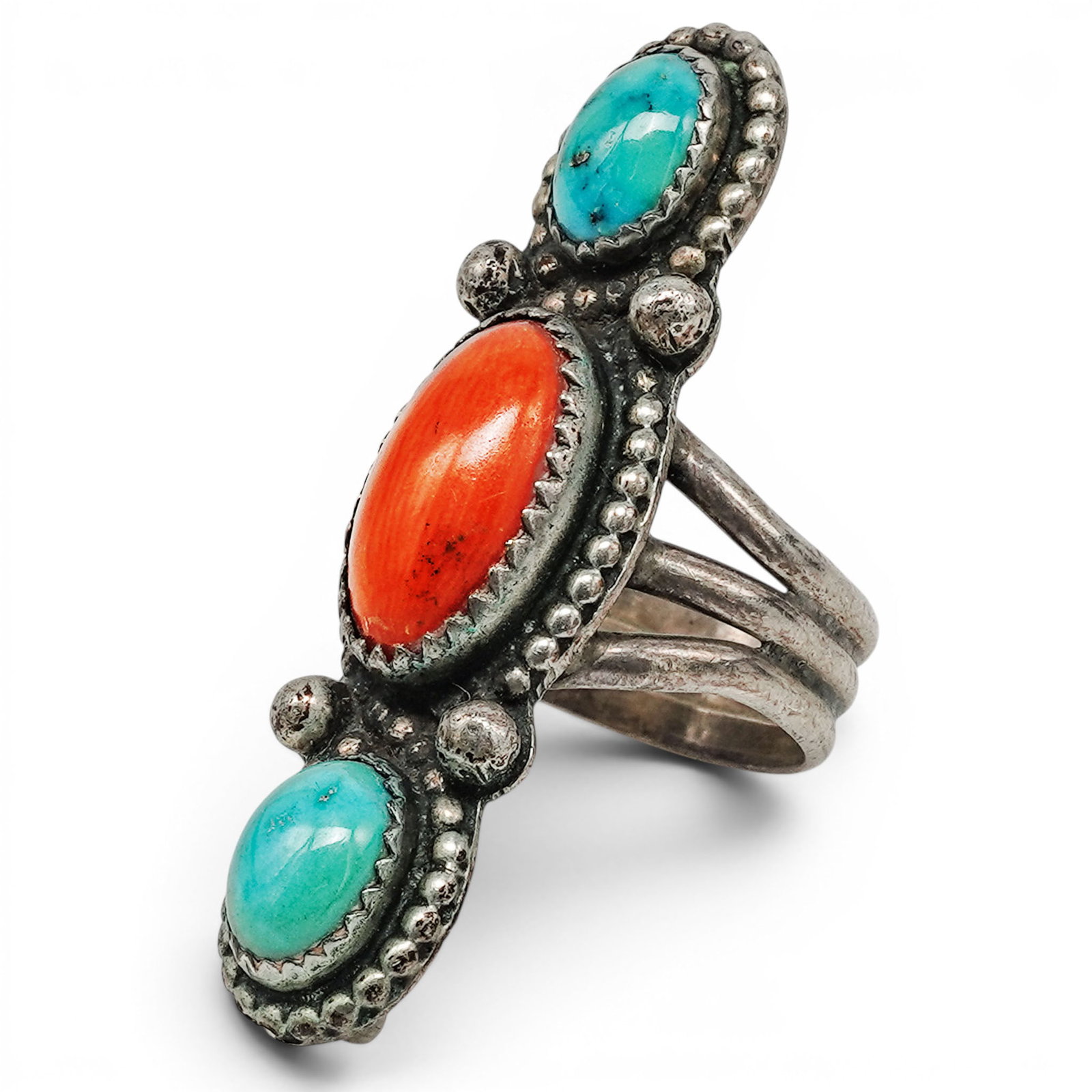 A Navajo Sterling Silver, Turquoise, And Coral Vertical Ring: A Navajo Sterling Silver, Turquoise, And Coral Vertical Ring Late 20th century Stamped: JT, unidentified maker's mark. Tested sterling silver. A vertical ring set with a central oval coral cabochon fl