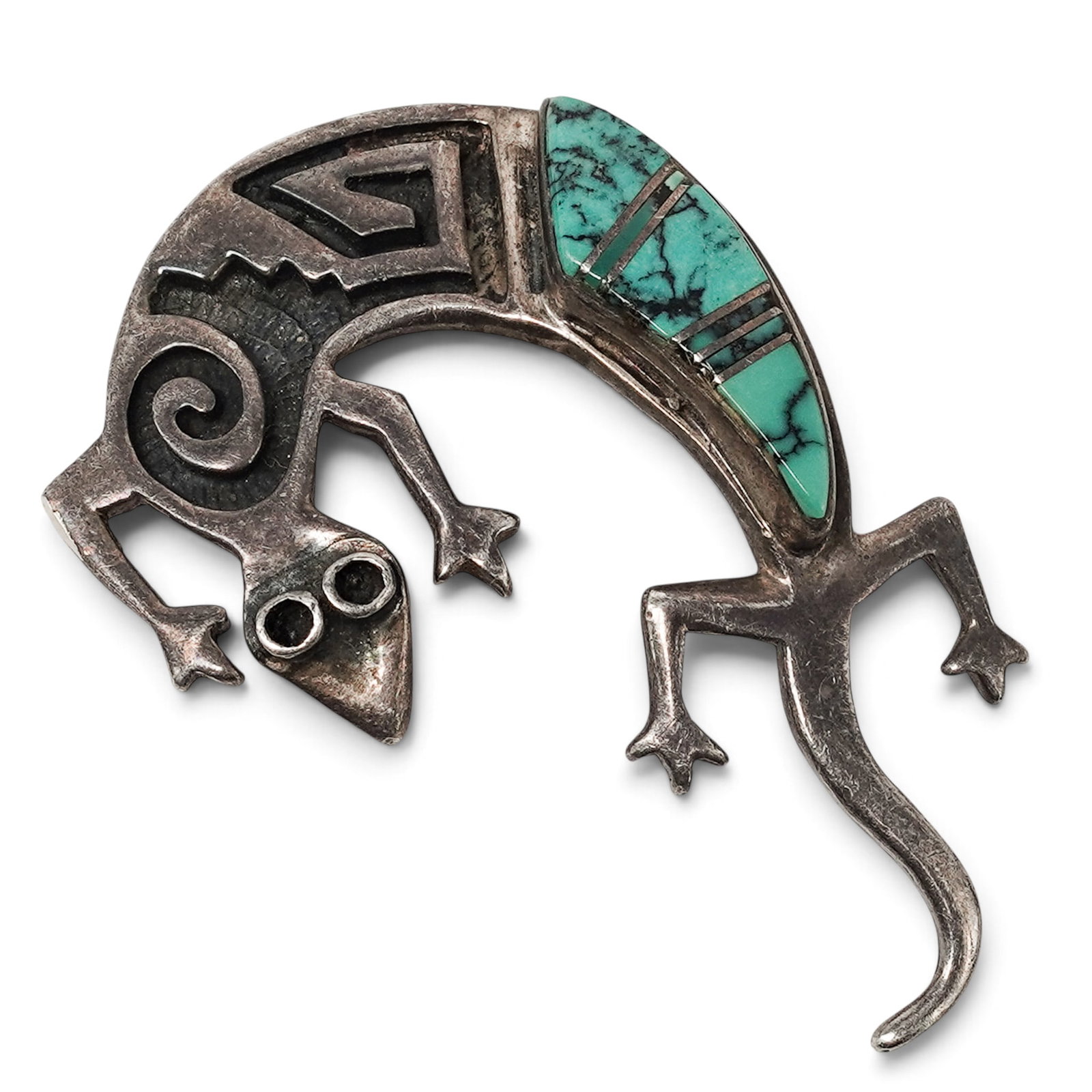 A Cynthia Begay Navajo Sterling Silver And Turquoise Lizard Brooch: A Cynthia Begay Navajo sterling silver and turquoise lizard brooch Late 20th Century Marked: C.B. hallmark / Sterling / Copyright hallmark. A stylized lizard brooch with geometric silverwork, scroll m