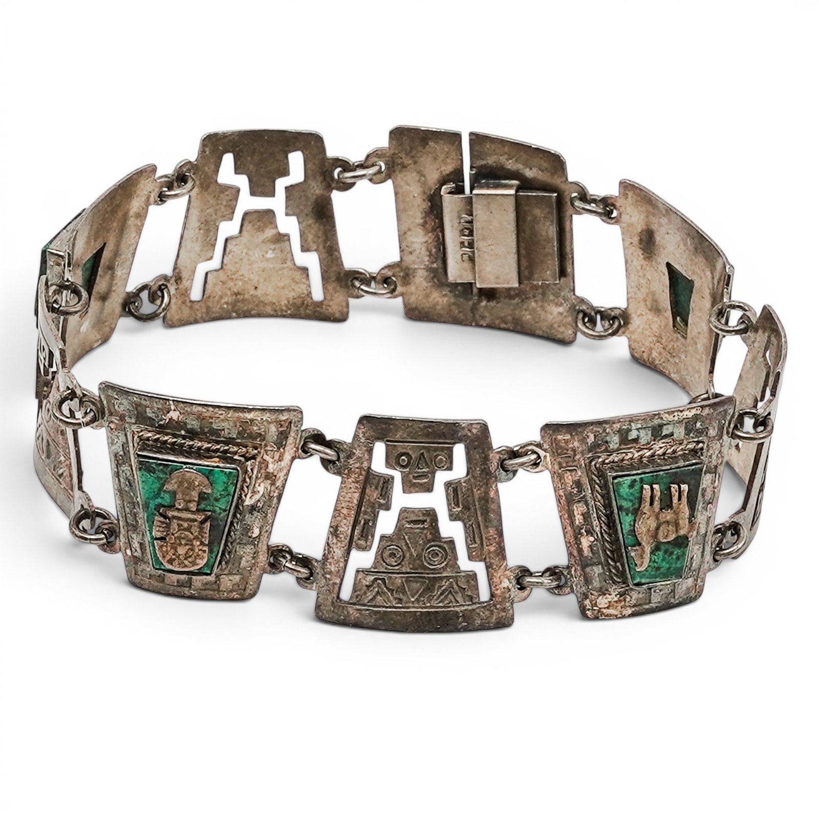 A Peruvian Sterling Silver And Malachite Figural Panel Bracelet: A Peruvian sterling silver and malachite figural panel bracelet Late 20th century Stamped: Peru / .925. An articulated bracelet composed of rectangular and curved panels with geometric and figural mot