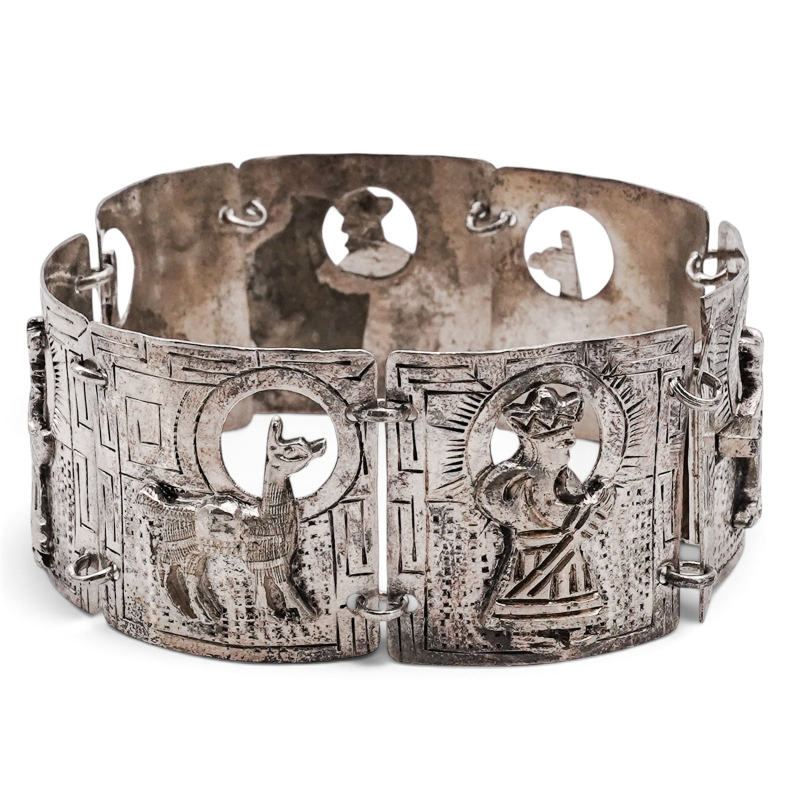 A Peruvian Sterling Silver Figural Panel Bracelet: A Peruvian sterling silver figural panel bracelet Late 20th century Stamped: .925 / CM / ESTERLIN. An articulated bracelet composed of curved rectangular panels with geometric engraving and applied fi