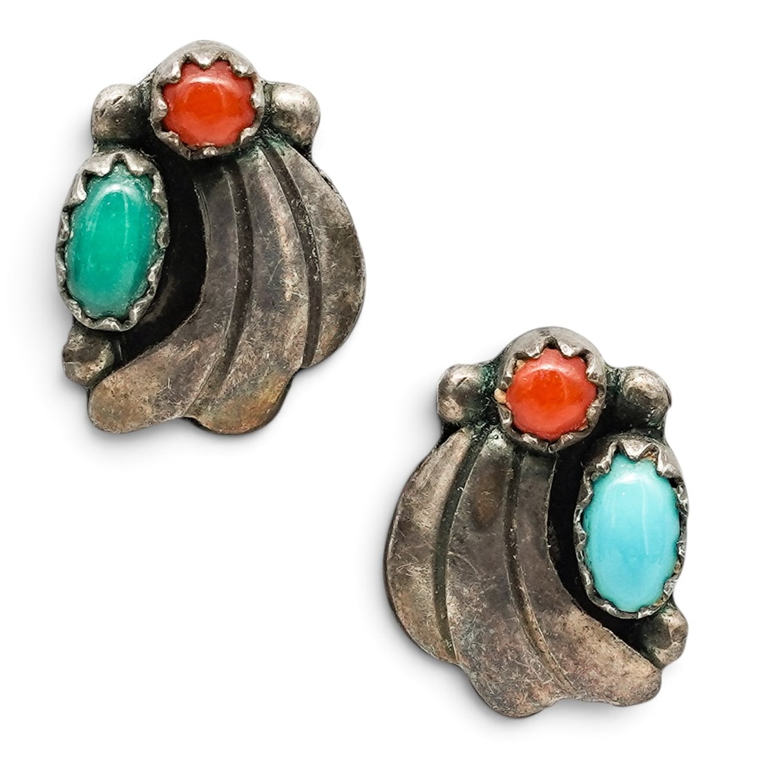 A Pair Of Navajo Sterling Silver, Turquoise, And Coral Fan Post Earrings: A pair of Navajo sterling silver, turquoise, and coral fan post earrings Late 20th century Unmarked. Tested sterling silver. Each with bezel-set turquoise and coral cabochons accented by layered silve