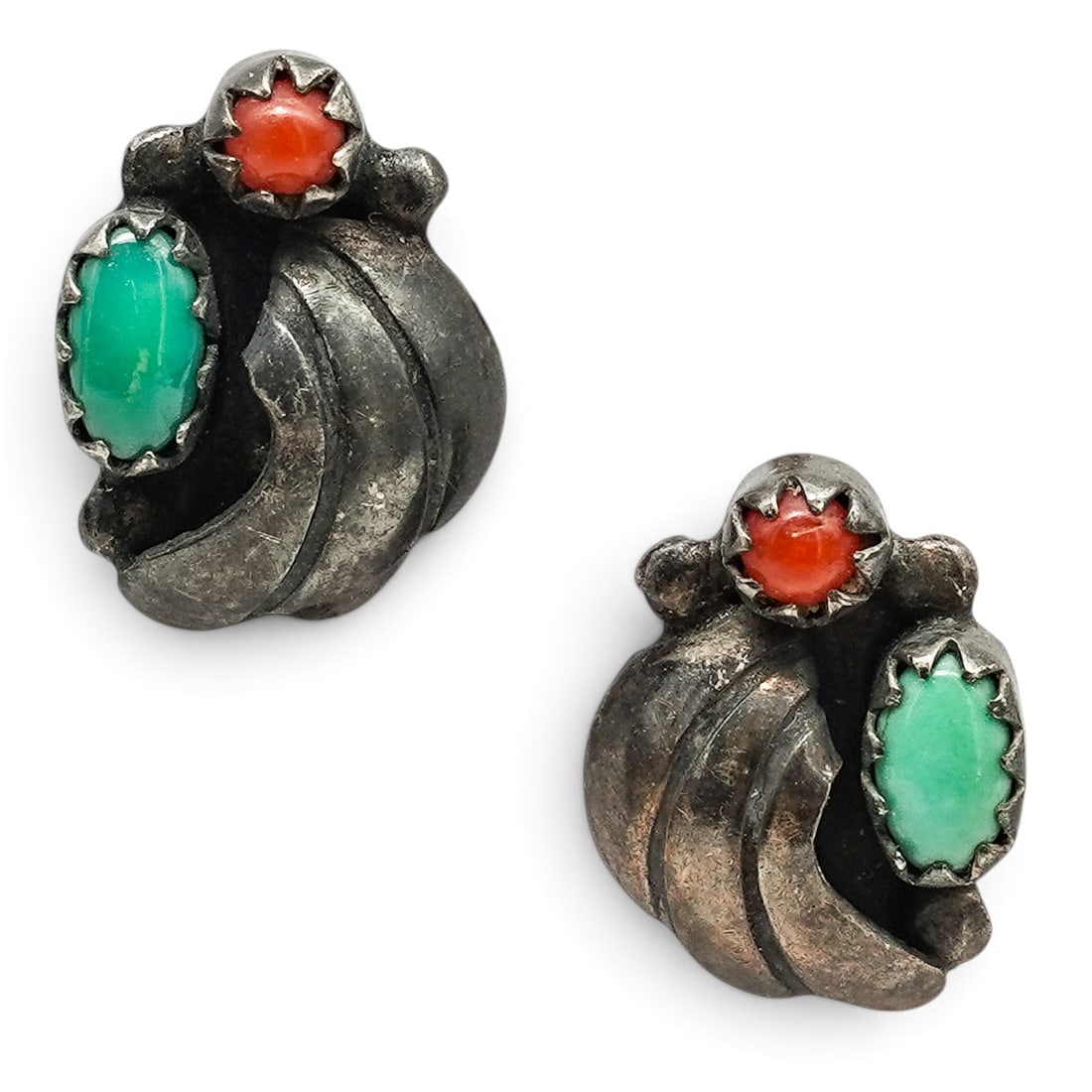 A Pair Of Navajo Sterling Silver, Turquoise, And Coral Leaf Post Earrings: A pair of Navajo sterling silver, turquoise, and coral leaf post earrings Late 20th century Unmarked. Tested sterling silver. Each with a bezel-set turquoise cabochon and coral accent nestled within o