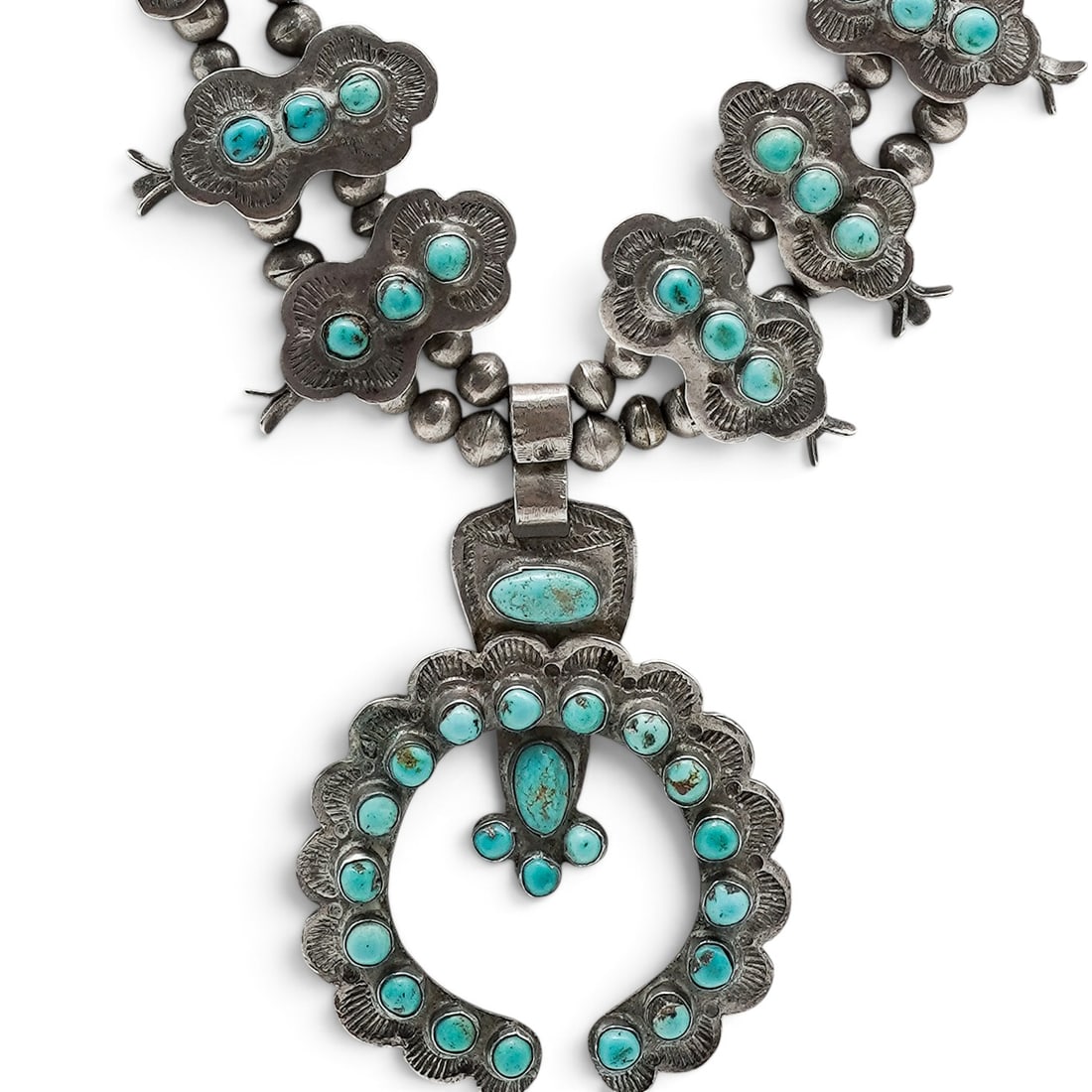 A Navajo Sterling Silver And Turquoise Cluster Squash Blossom Necklace: A Navajo sterling silver and turquoise cluster squash blossom necklace Late 20th Century Unmarked. Tested sterling silver. A necklace with turquoise cluster squash blossoms suspended from a strand of 