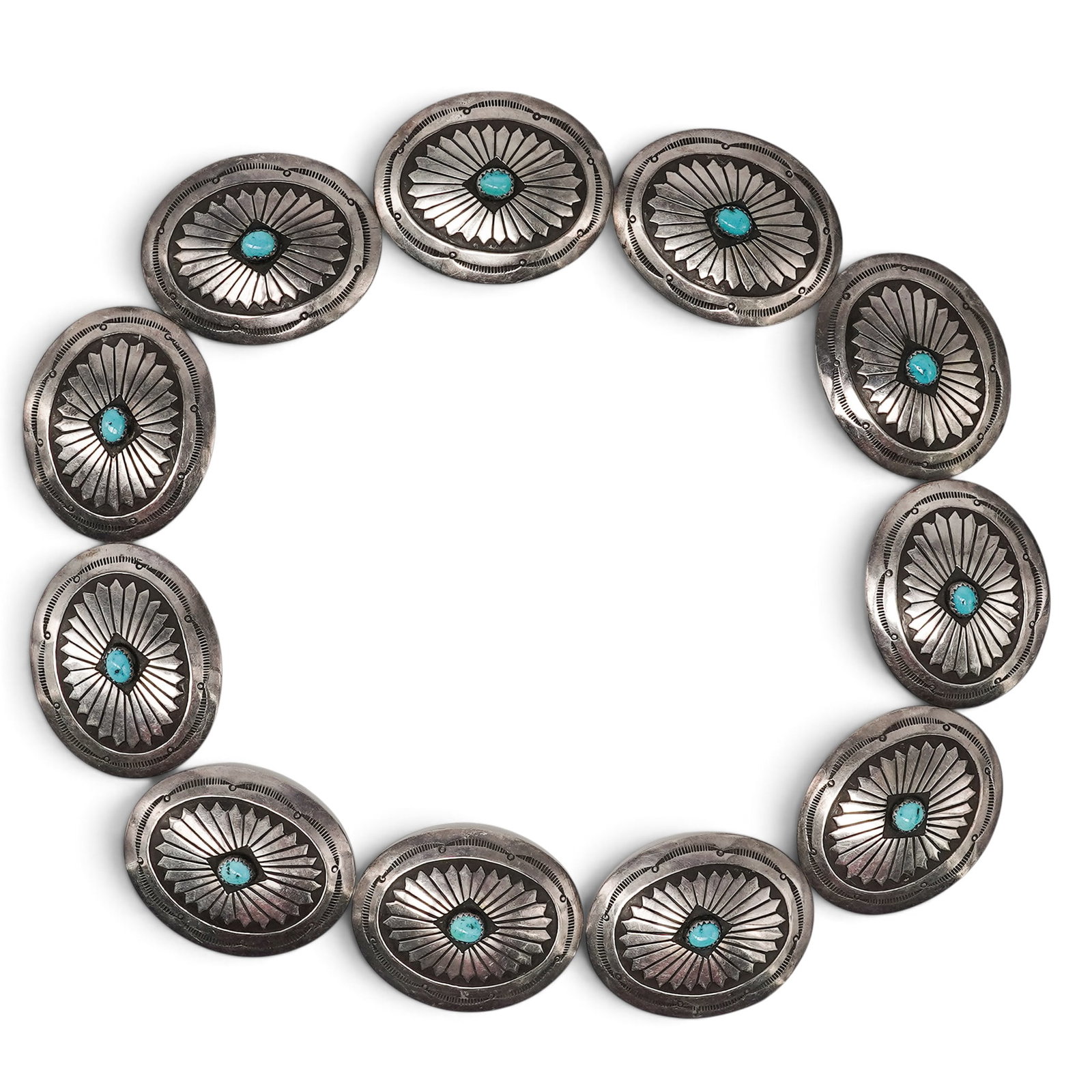 (11 Pcs) A Navajo Sterling Silver And Turquoise Concho Belt: (11 Pcs) A Navajo sterling silver and turquoise concho belt Late 20th century Unmarked. Tested sterling silver. Comprising of eleven oval conchos, each centered by a turquoise cabochon in a serrated b