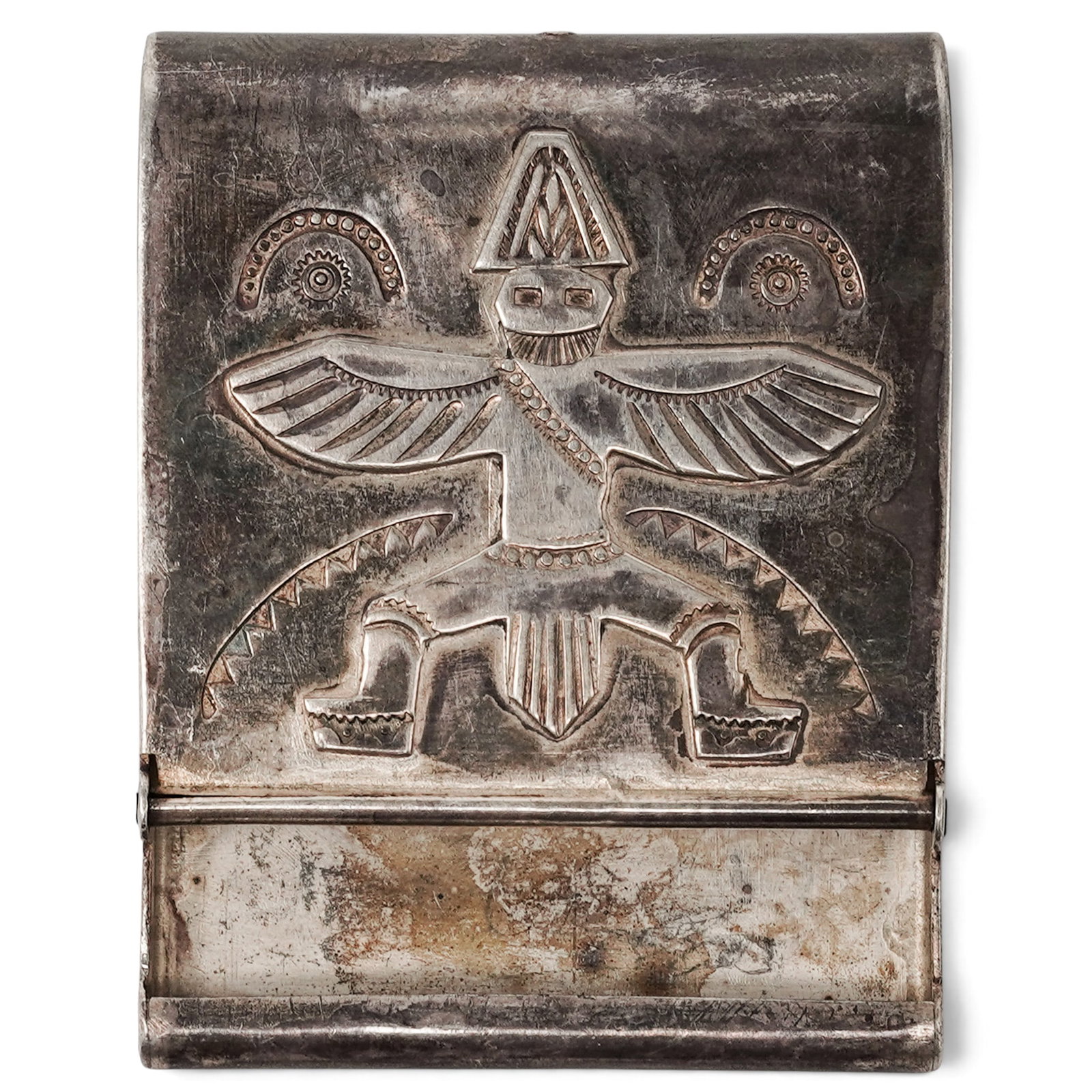 A Navajo Sterling Silver Thunderbird Belt Buckle: A Navajo sterling silver Thunderbird belt buckle Late 20th Century Unmarked. Tested sterling silver. A rectangular belt buckle engraved with a stylized thunderbird motif, accented by geometric and rad