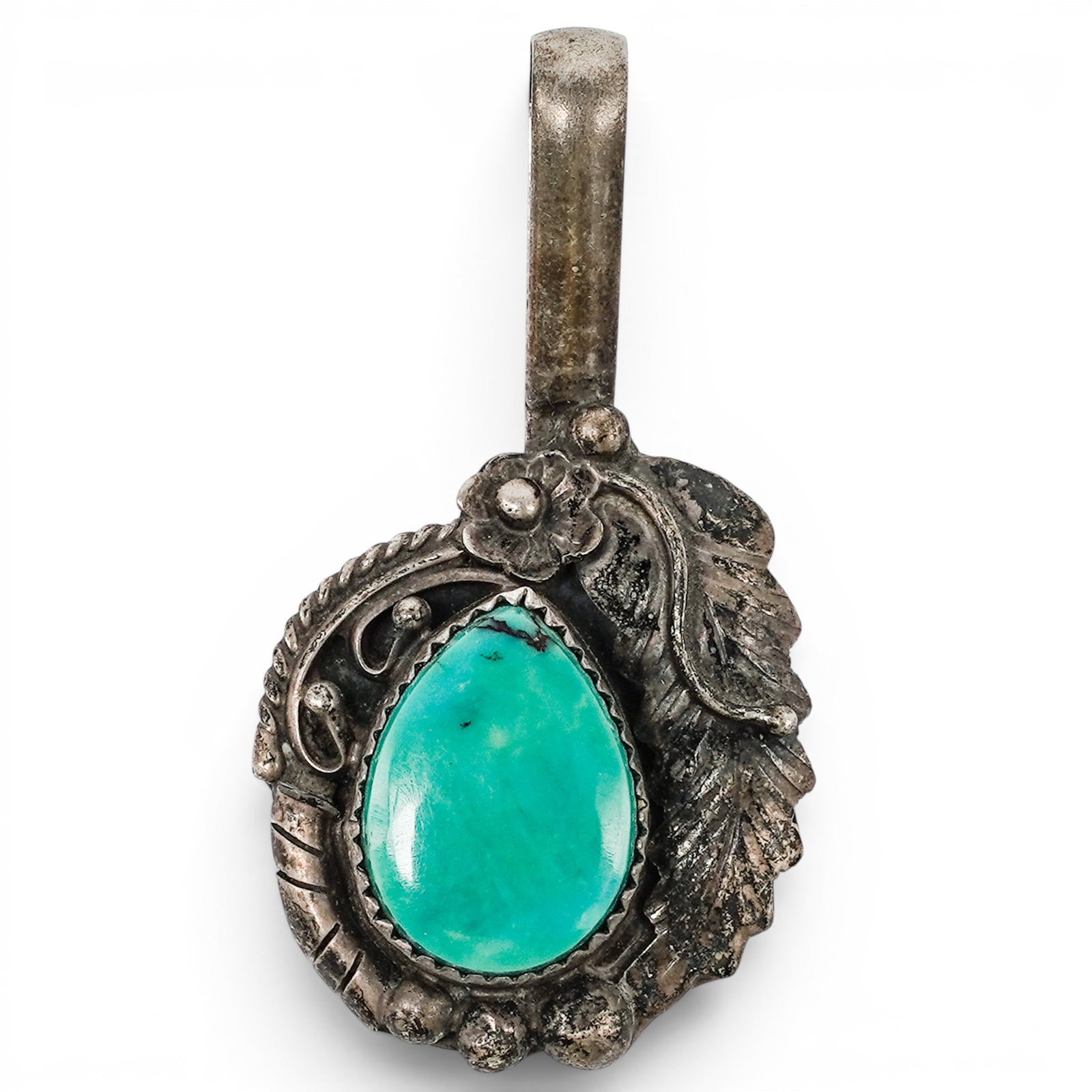 A Navajo Sterling Silver And Turquoise Foliate Pendant: A Navajo sterling silver and turquoise foliate pendant Late 20th century Stamped: A.S.P., unidentified signature / Sterling. A pendant set with a pear-shaped turquoise cabochon in a serrated bezel, ac