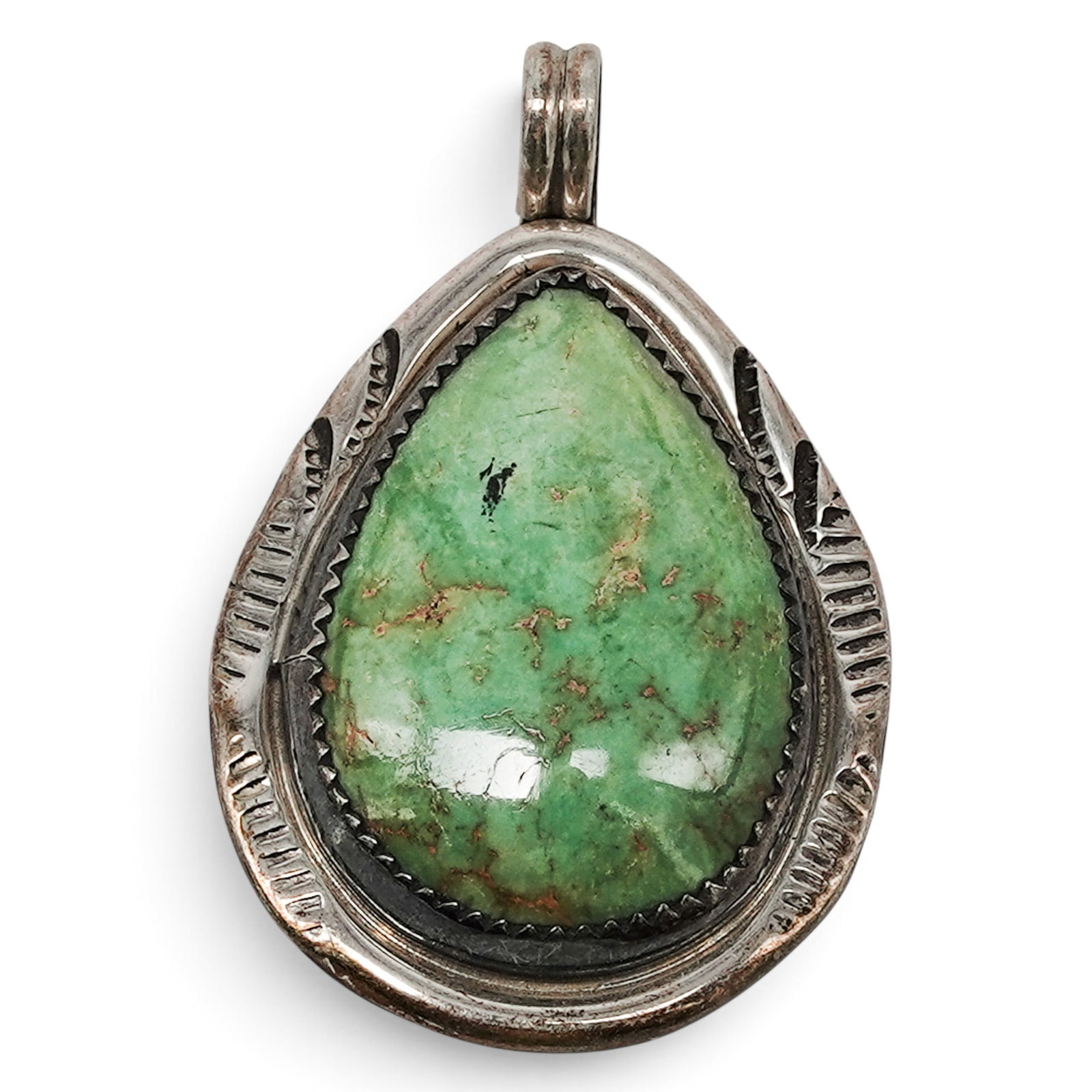 A Clayton Tom Navajo Sterling Silver And Green Turquoise Pendant: A Clayton Tom Navajo sterling silver and green turquoise pendant Late 20th century Stamped: C.T. / Sterling A pendant set with a large pear-shaped green turquoise cabochon in a serrated bezel, framed 