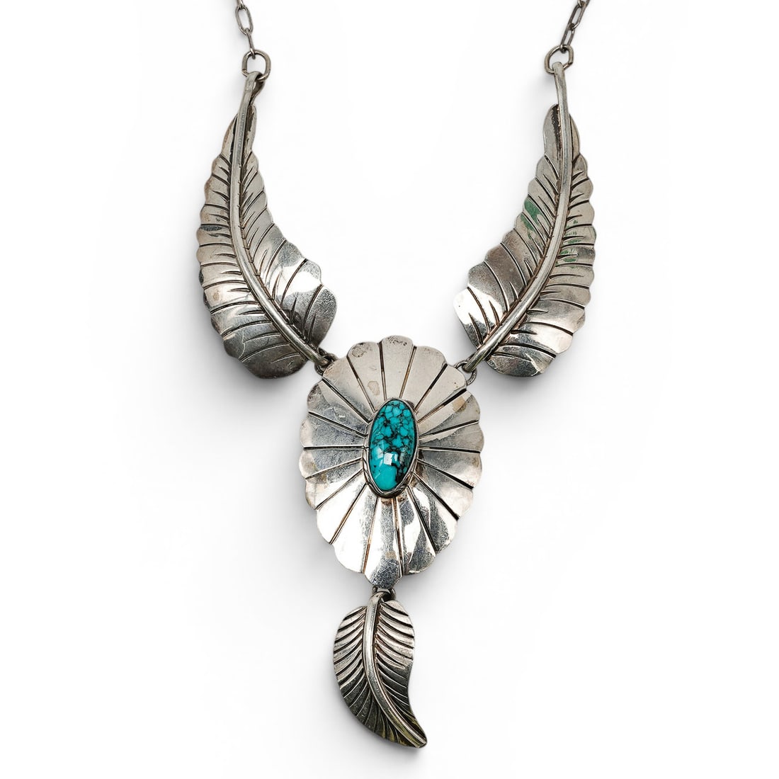 A Renell Perry For Sun West Silver Co Sterling Silver And Turquoise Leaf Motif Pendant Necklace: A Renell Perry for Sun West Silver Co sterling silver and turquoise leaf motif pendant necklace Late 20th century Stamped: Renell Perry / Sun West Silver Co / Sterling A pendant necklace with three ar