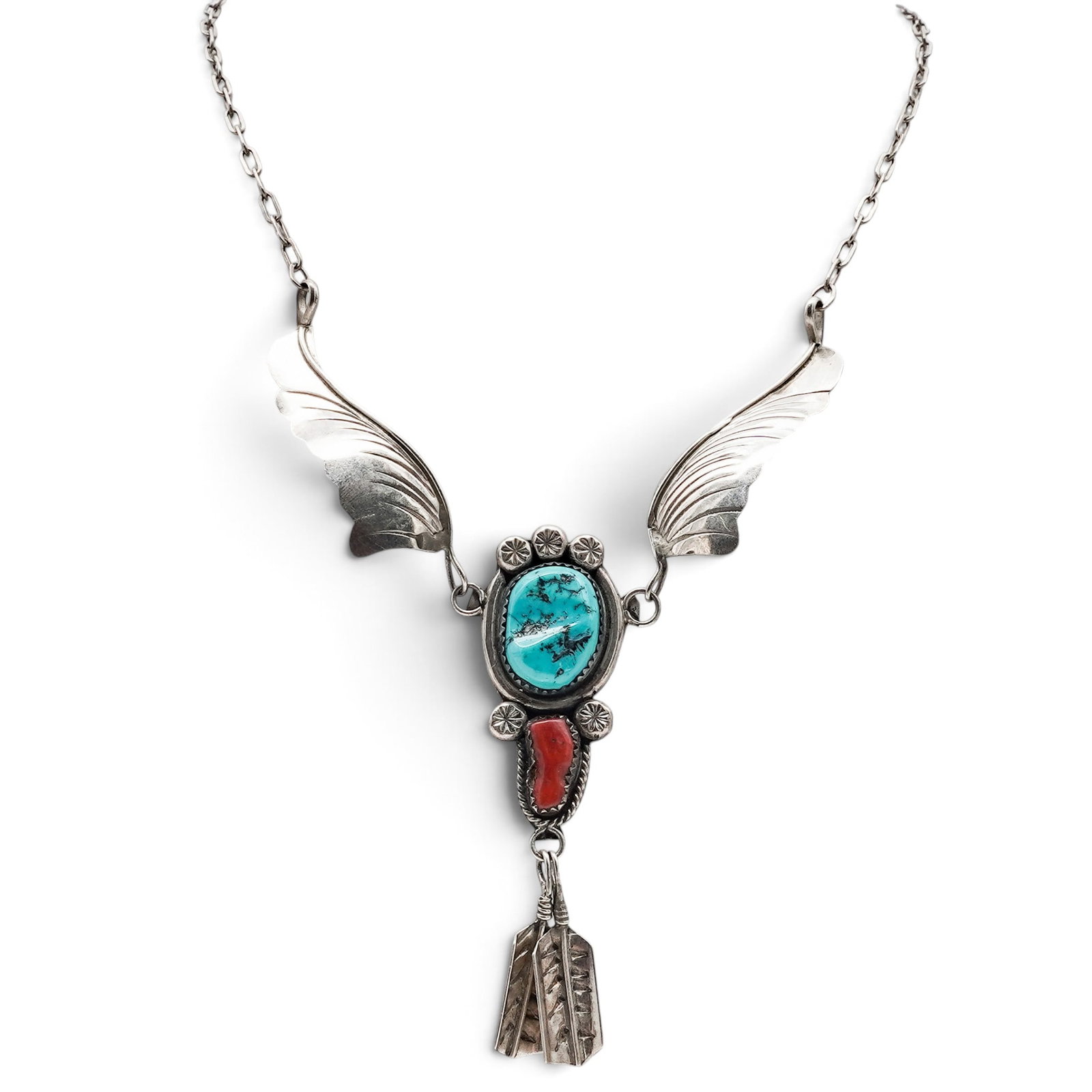 A Melissa Yazzie Navajo Sterling Silver, Turquoise, And Coral Feather Pendant Necklace: A Melissa Yazzie Navajo sterling silver, turquoise, and coral feather pendant necklace Late 20th Century Stamped: M / Sterling. A pendant necklace with a central bezel-set turquoise cabochon and coral