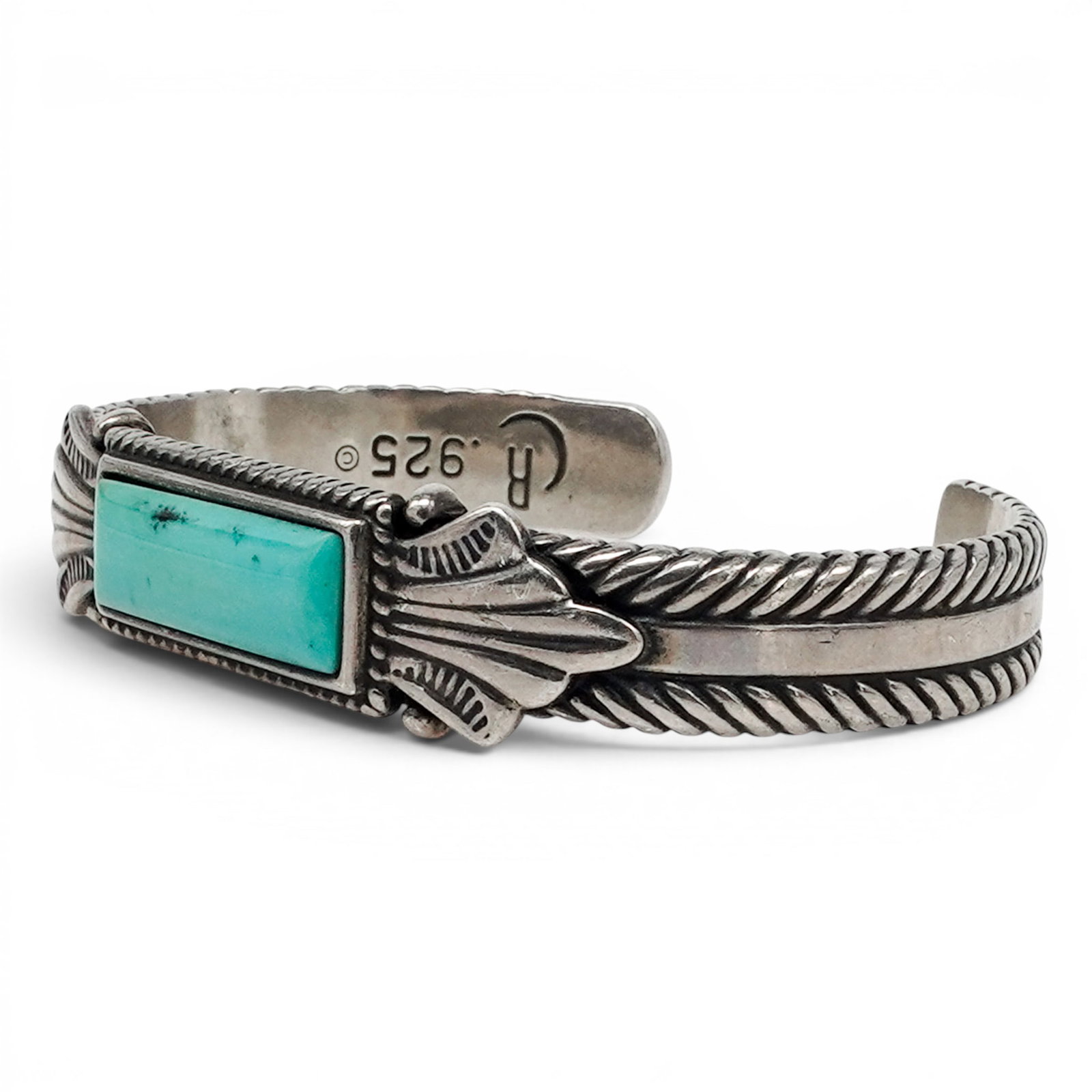 A Relios Southwest Sterling Silver And Turquoise Rectangular Stone Cuff Bracelet: A Relios Southwest sterling silver and turquoise rectangular stone cuff bracelet Late 20th century Stamped: Relios hallmark / .925 A cuff bracelet with a rectangular turquoise stone in a bezel setting
