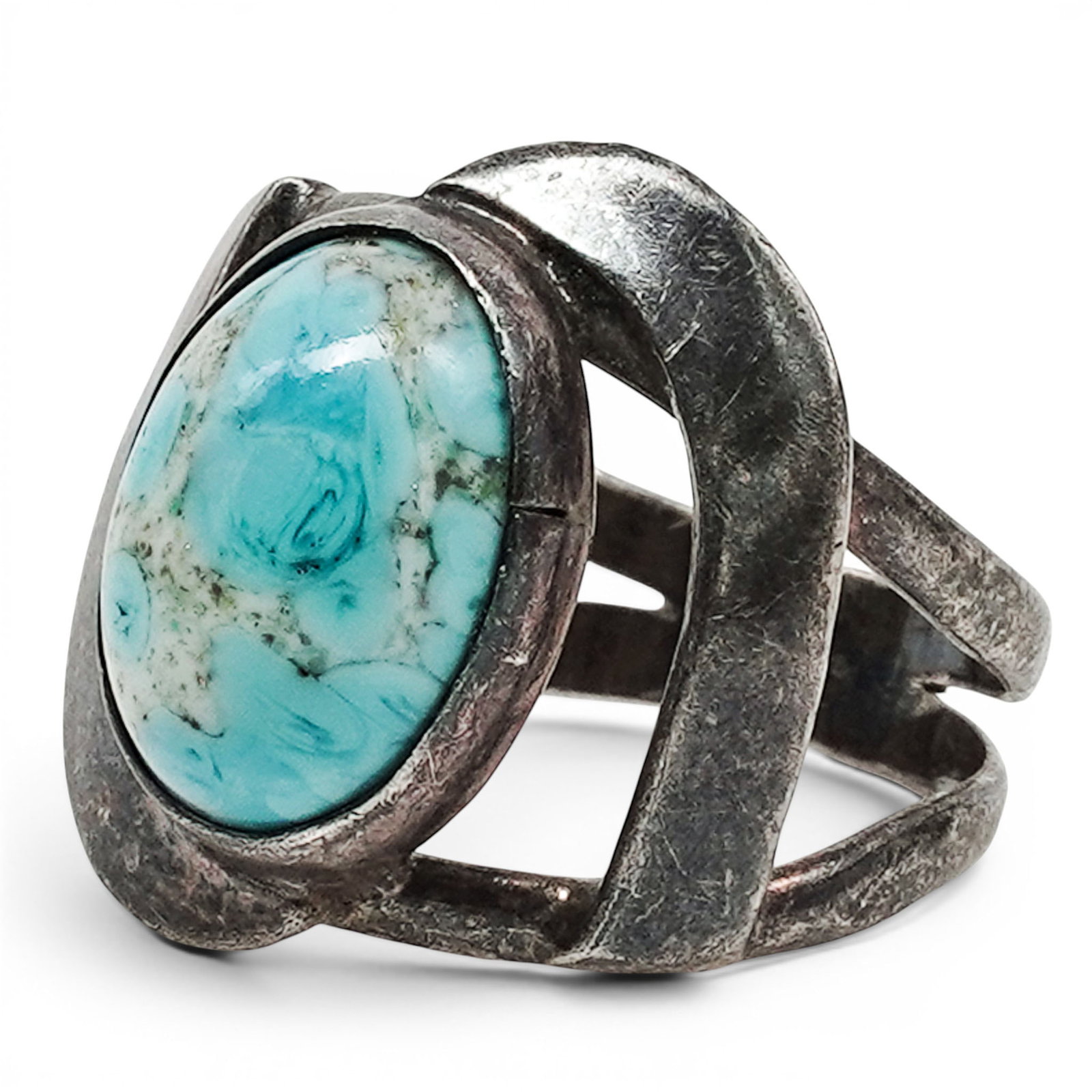 A Mexican Sterling Silver And Turquoise Ring: A Mexican sterling silver and turquoise ring Late 20th century Stamped: Mexico / .925 / CDM A wide tapering ring with an oval bezel-set turquoise cabochon mounted within an openwork silver setting. 5.