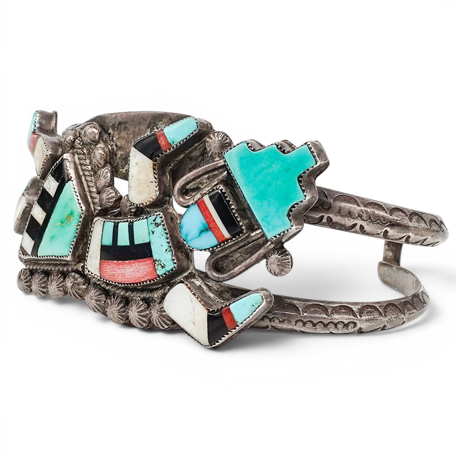 A Navajo Sterling Silver And Multistone Figural Inlay Cuff Bracelet: A Navajo sterling silver and multistone figural inlay cuff bracelet Late 20th century Unmarked. Tested sterling silver. A wide cuff bracelet with multistone channel inlay depicting a stylized Yei-styl